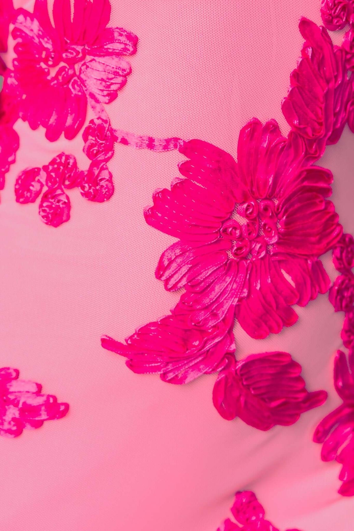 Close-up of vibrant pink floral embroidery on mesh fabric of a Parfait Maxi Dress.