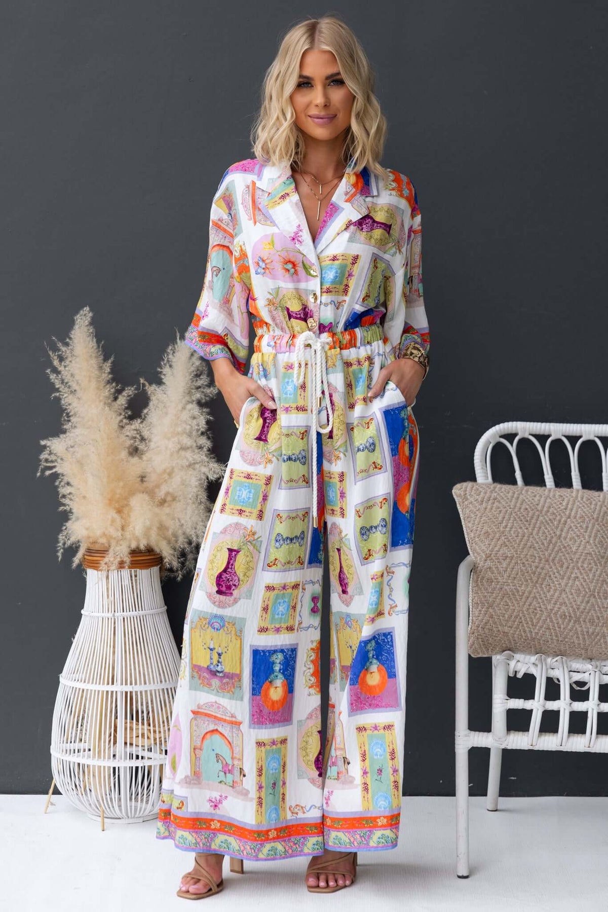 Stylish Perrin jumpsuit in vibrant print with collar, button-up front, elastic waistband and pockets, perfect for relaxed wear.