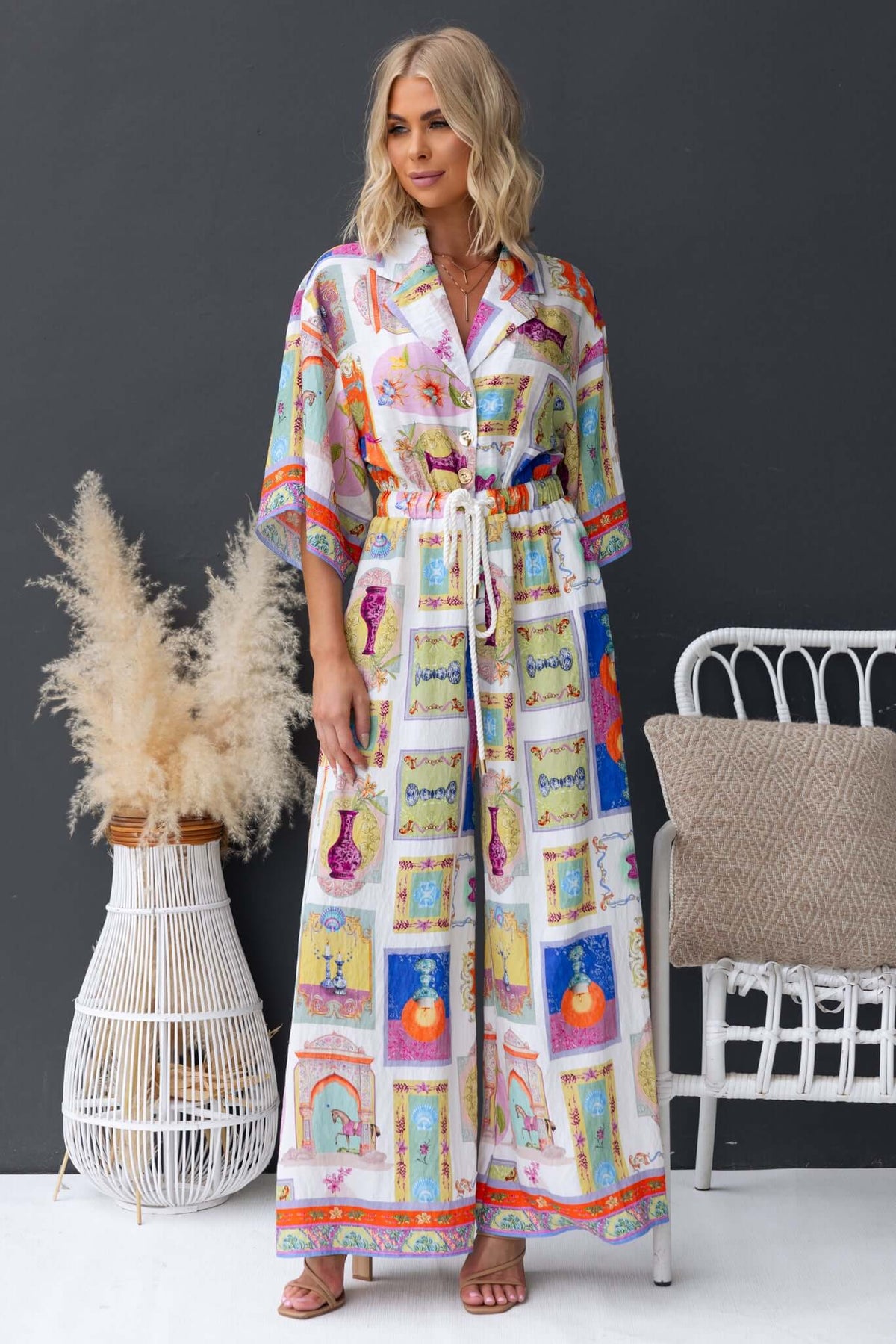 Perrin Jumpsuit with collar, button-up front, and elastic waistband, styled in colorful design, perfect for a relaxed fit.