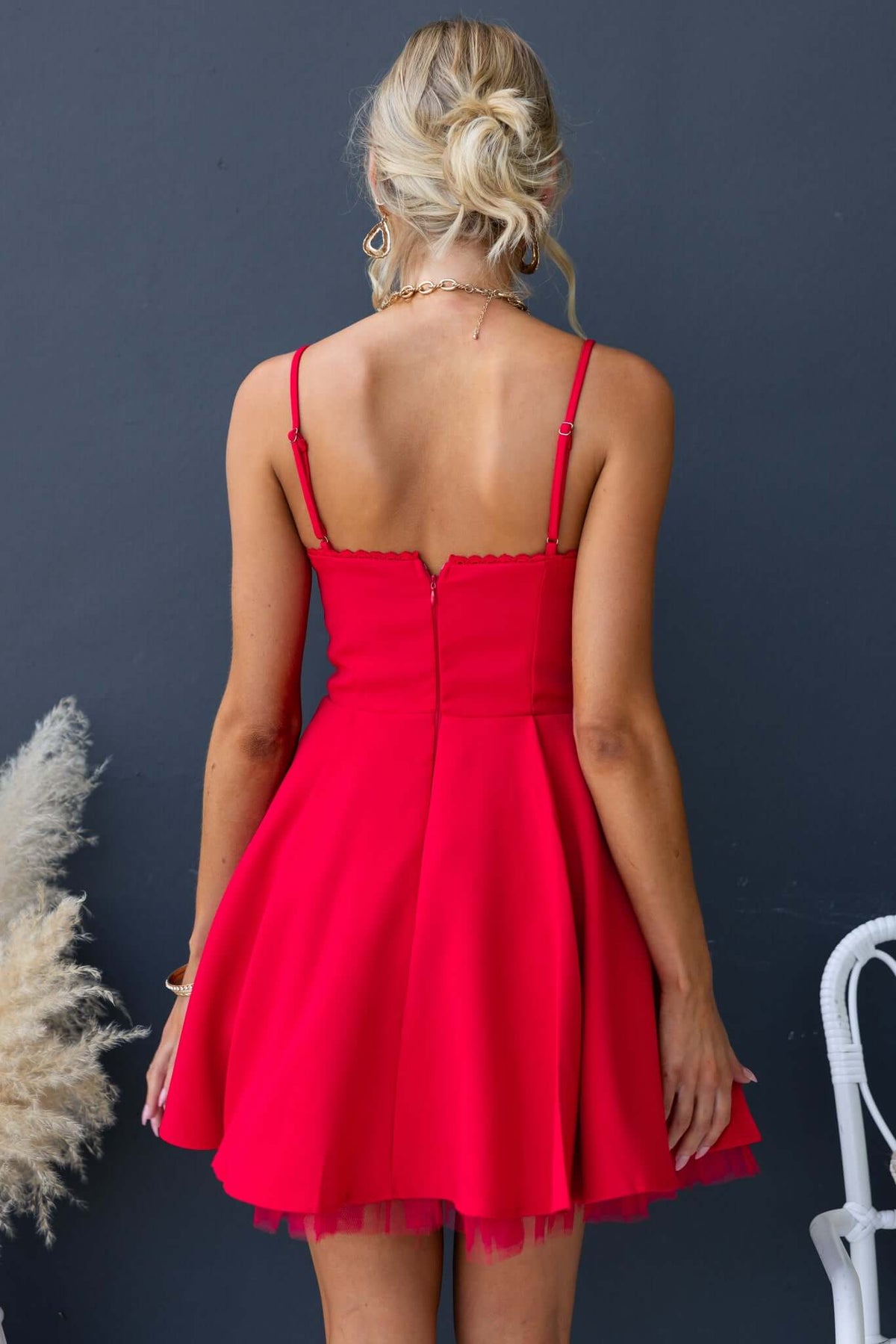 Back view of the Pescia Dress featuring adjustable straps, invisible zip, and tulle underlay in vibrant red.