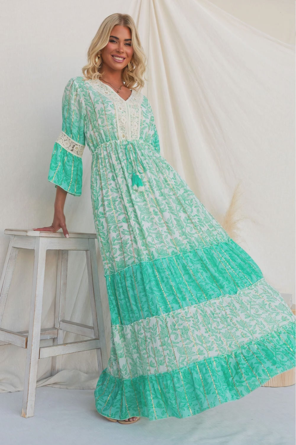 Model wearing a Mystic Maxi Dress with V-neckline and pockets, featuring a vibrant metallic print.