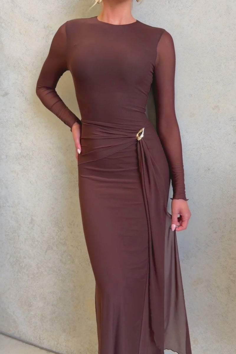 La Rose Maxi Dress worn by model, featuring a round neckline, draping material, and gold hardware.