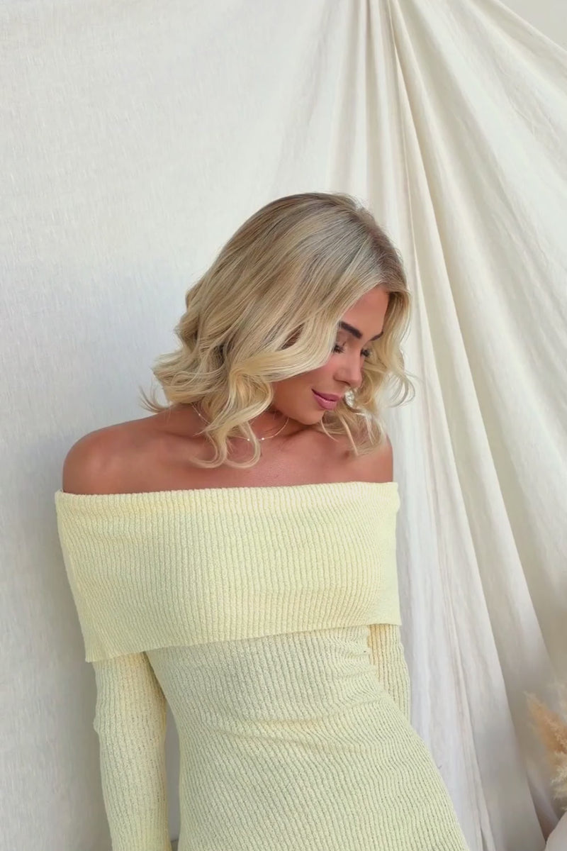 Model wearing off-shoulder Breeze Midi Dress in ribbed knit material, showcasing elegant style.