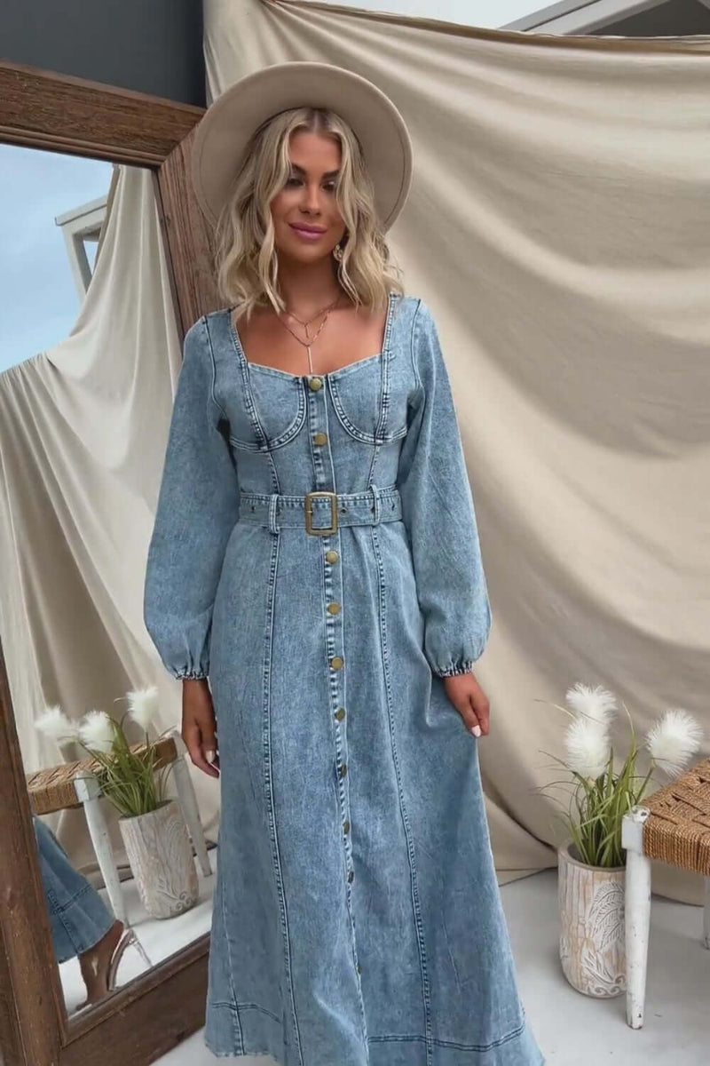 Model wearing a Rome Denim Maxi Dress with faux button-up front, elastic sleeves, and removable belt against a neutral backdrop.