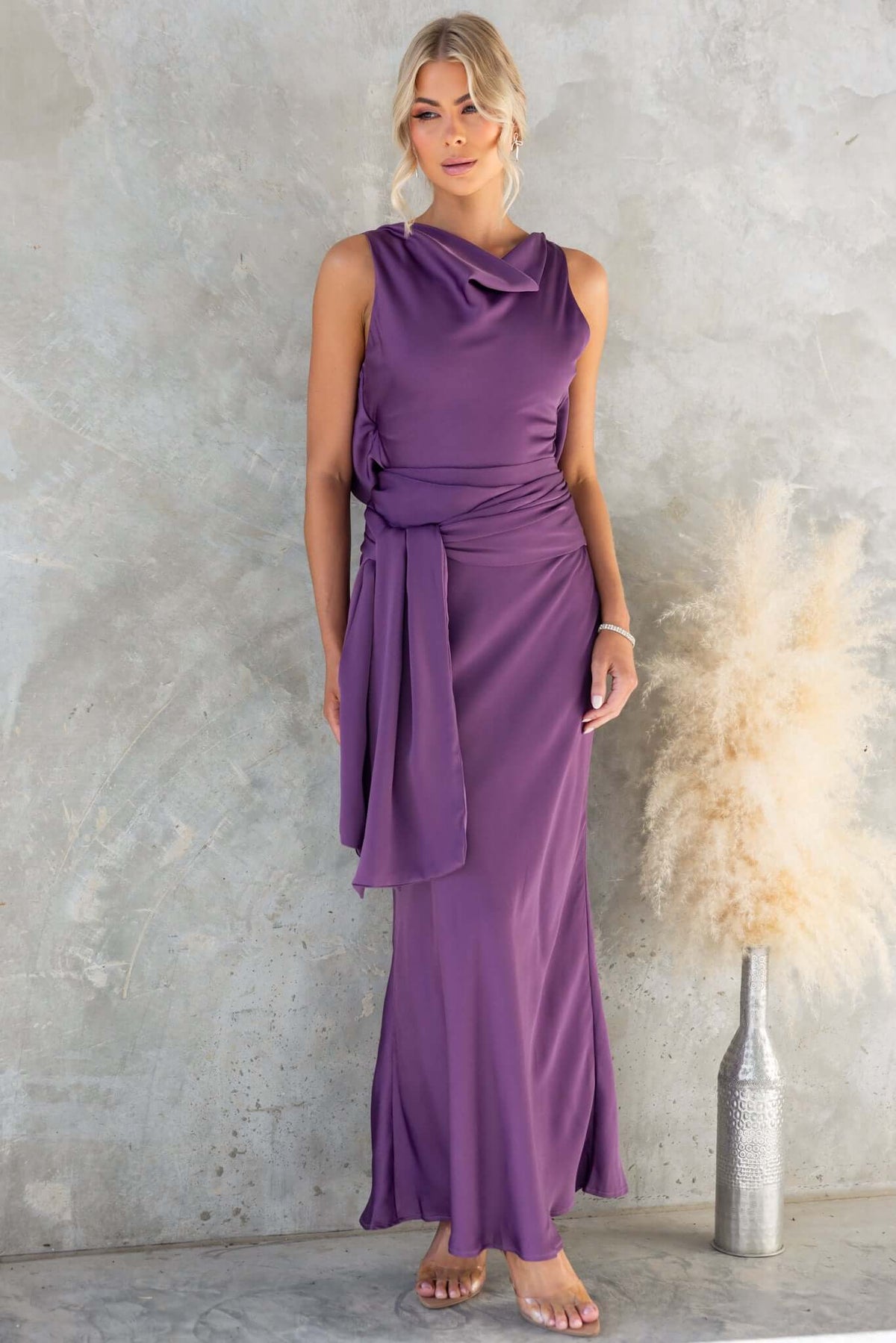 Qalenna Maxi Dress in purple, featuring high neckline, open back tie, and flowy satin material.