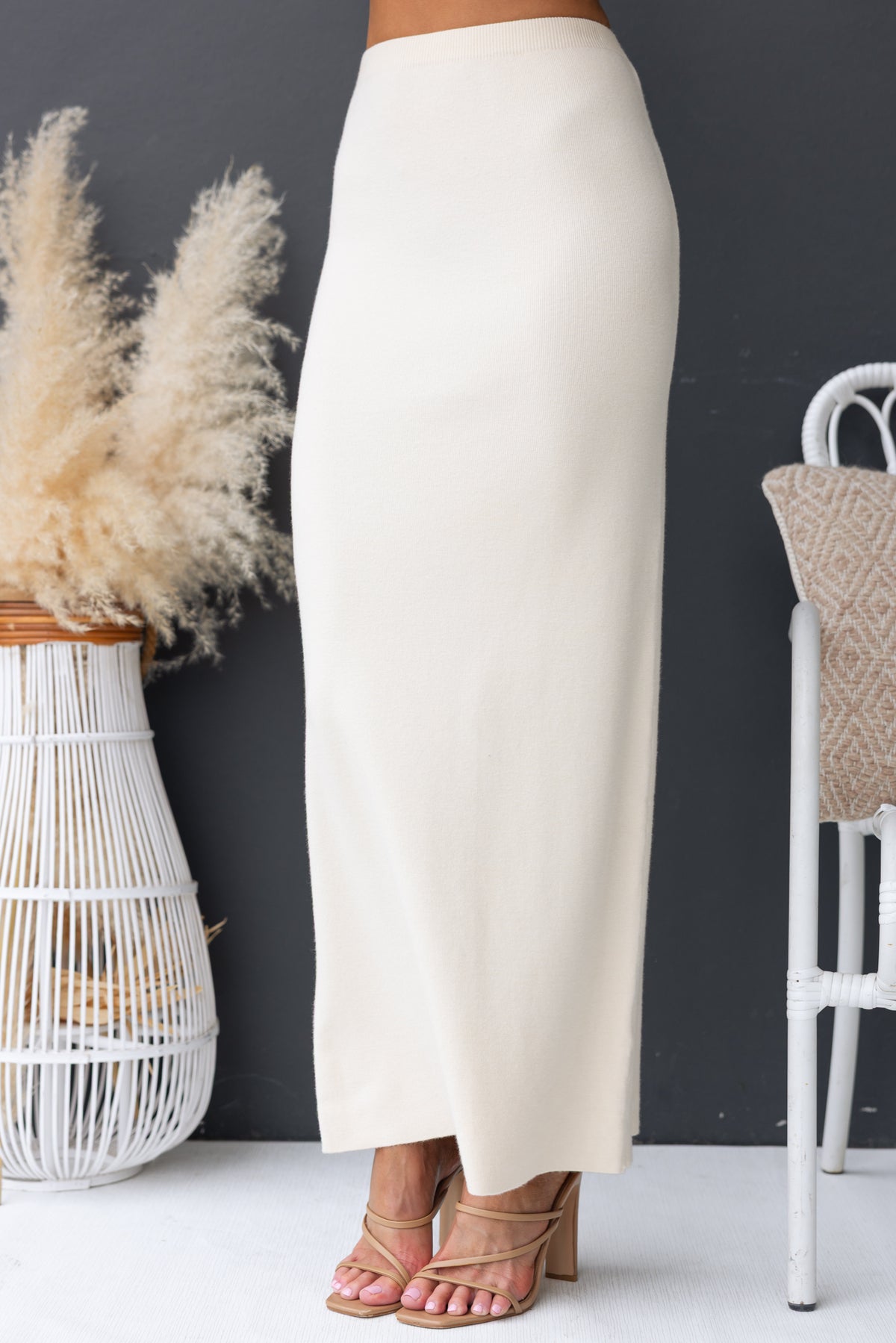 Qarmy Maxi Skirt in cream color, featuring mid-high waist fit and stretch knit material, perfect for casual style.