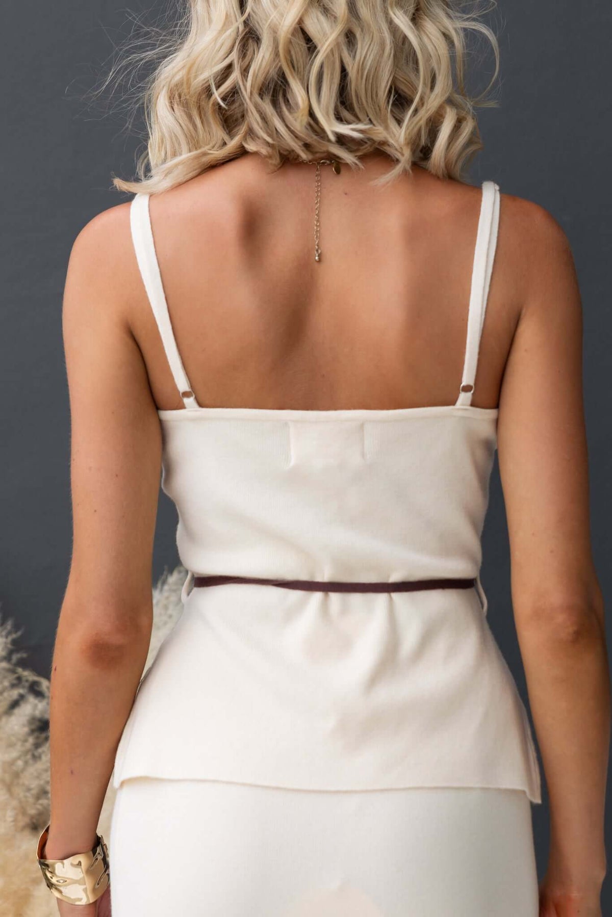 Back view of Qarmy Top with adjustable straps and removable tie, in knit material with a fitted silhouette.