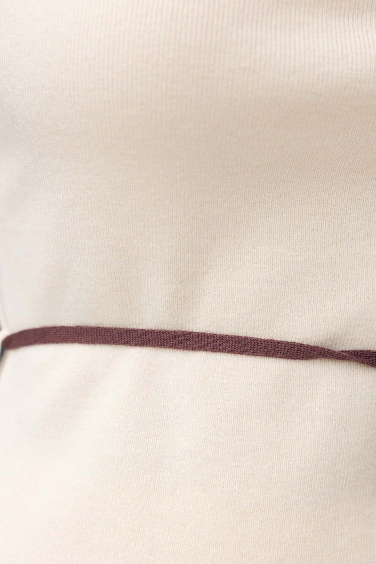 Close-up of Qarmy Top showing adjustable straps and removable tie detail in soft knit fabric.