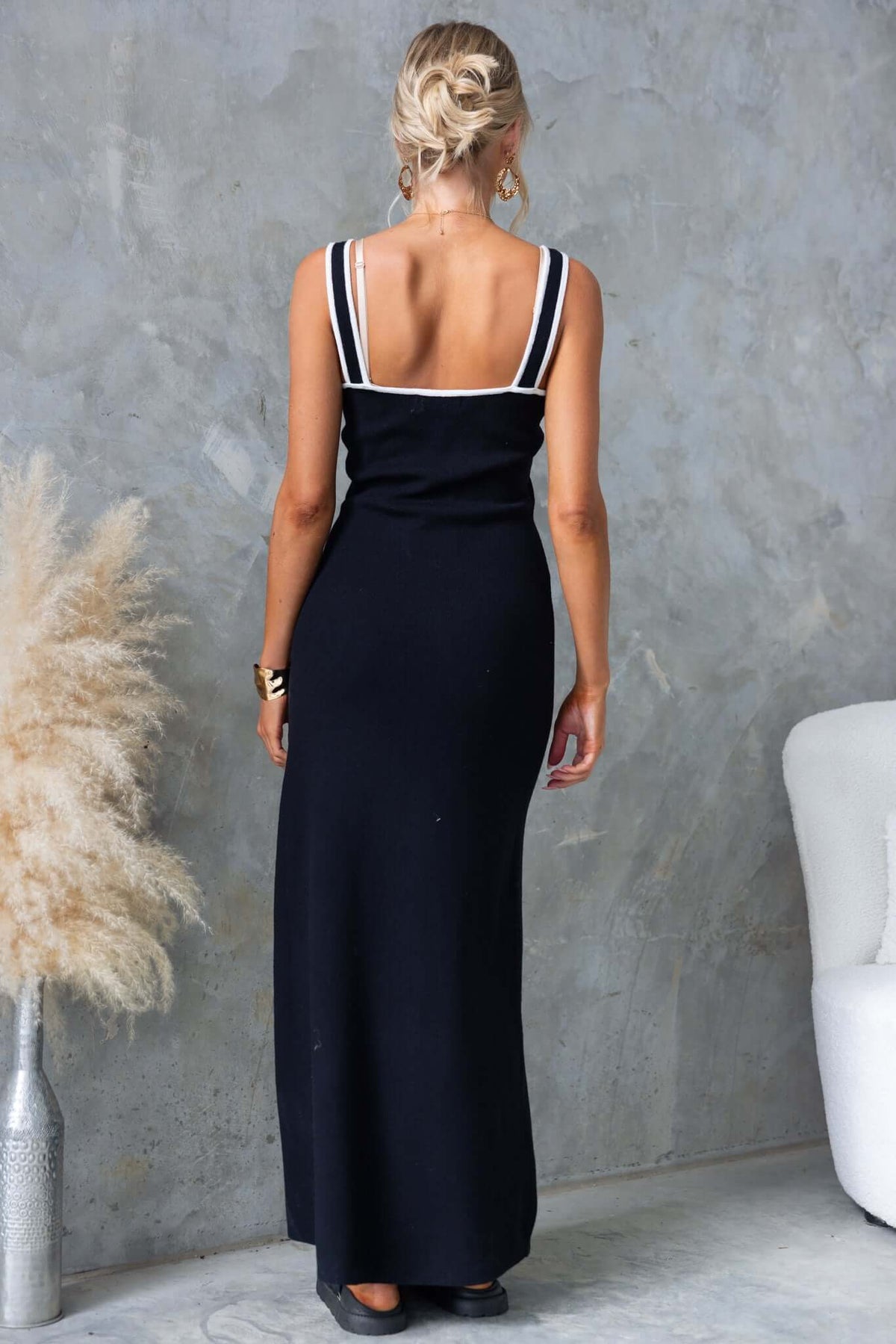 Model wearing Qulver Maxi Dress from the back, showcasing ribbed knit material and faux button details.
