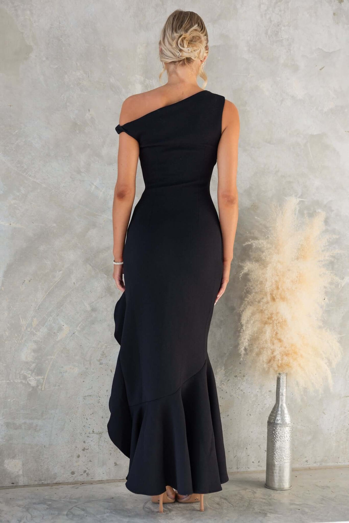 Raleigh Maxi Dress with asymmetric neckline and hem, showcasing a figure-hugging fit, ideal for elegant occasions.