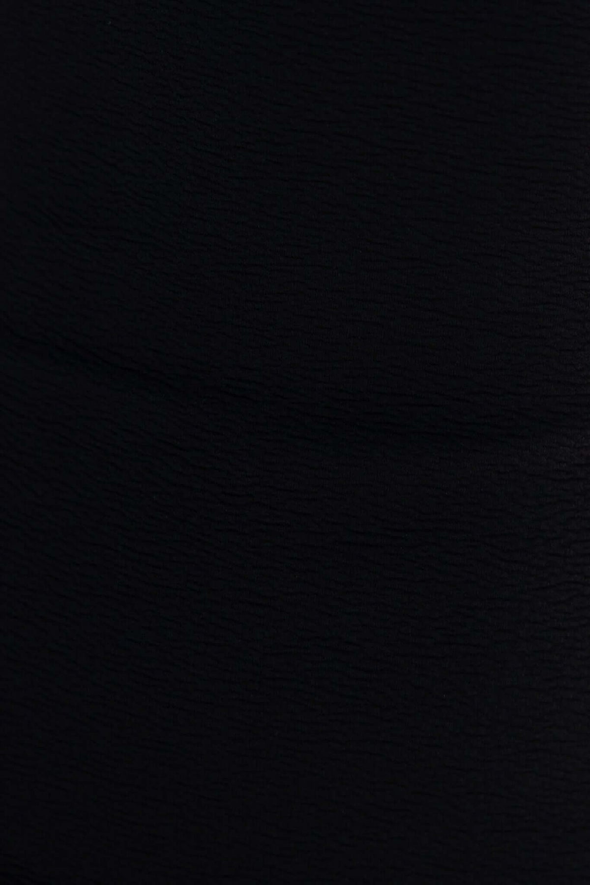 Close-up of black textured fabric showcasing the material of the Raleigh Maxi Dress.