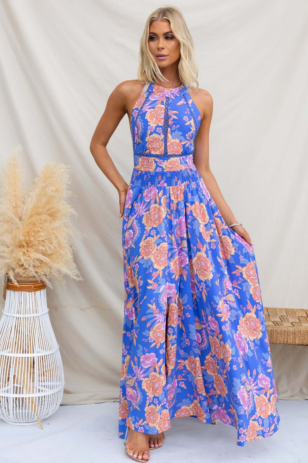 Relly Maxi Dress featuring an abstract floral print, high halter neckline, and a front split, perfect for summer outings.