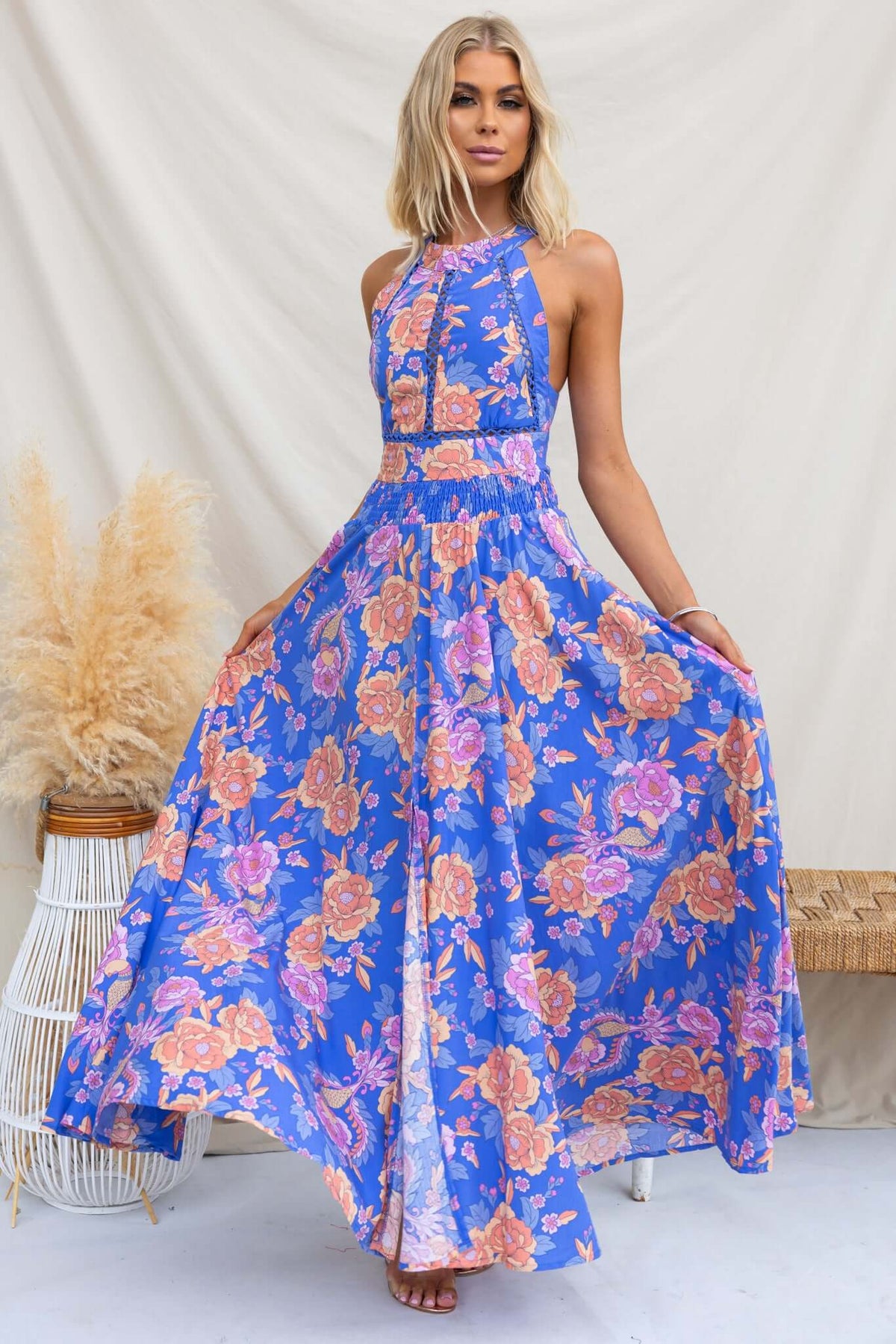 Elegant Relly Maxi Dress featuring an abstract floral print, high halter neckline, and a stylish front split.
