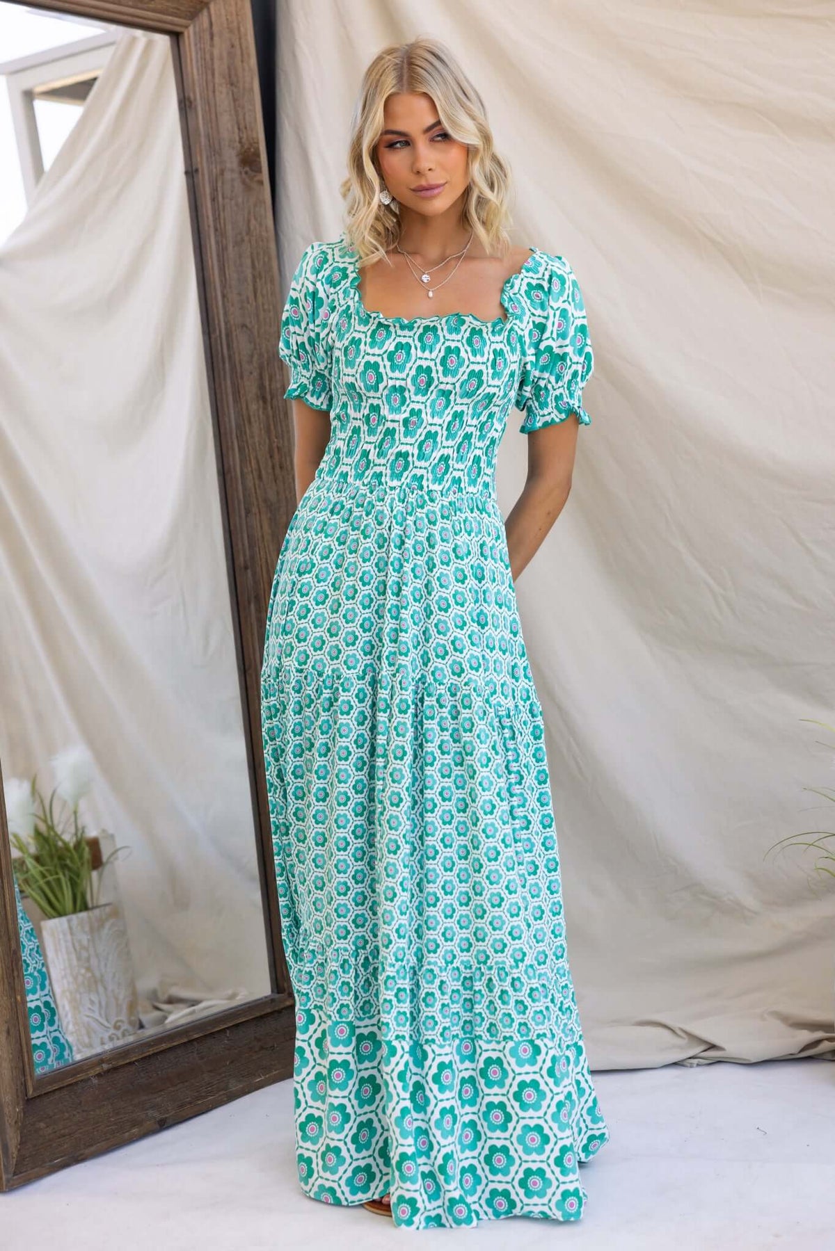 Right Time Maxi Dress in green floral pattern, featuring puff sleeves and elastic bodice, styled in a mirror setting.
