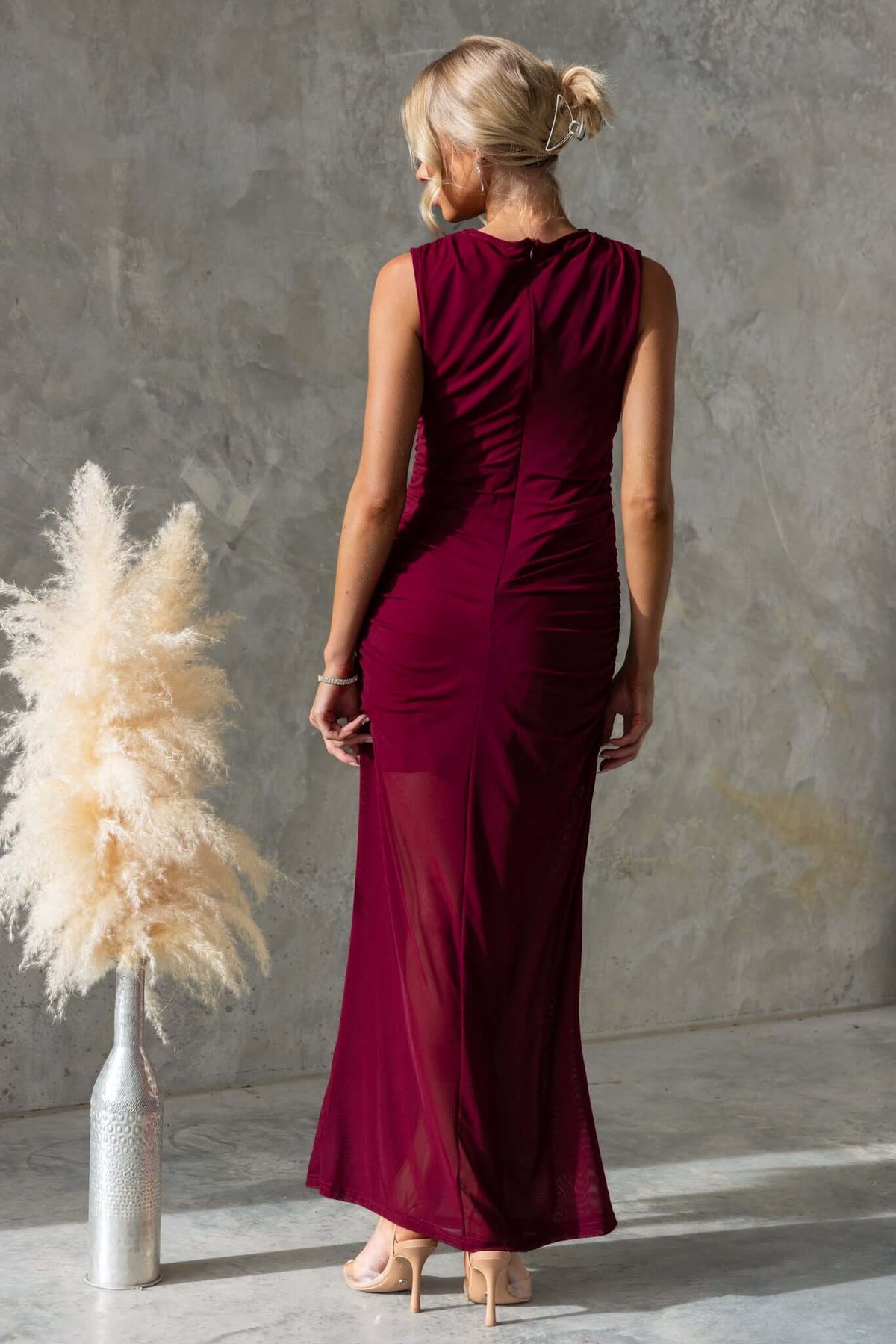 Rogers Maxi Dress in burgundy with high neckline, showing back view and mesh material in a stylish indoor setting.