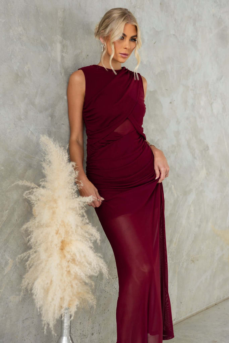 Rogers Maxi Dress in burgundy with high neckline and mesh material, featuring an elegant fit and side cutouts.