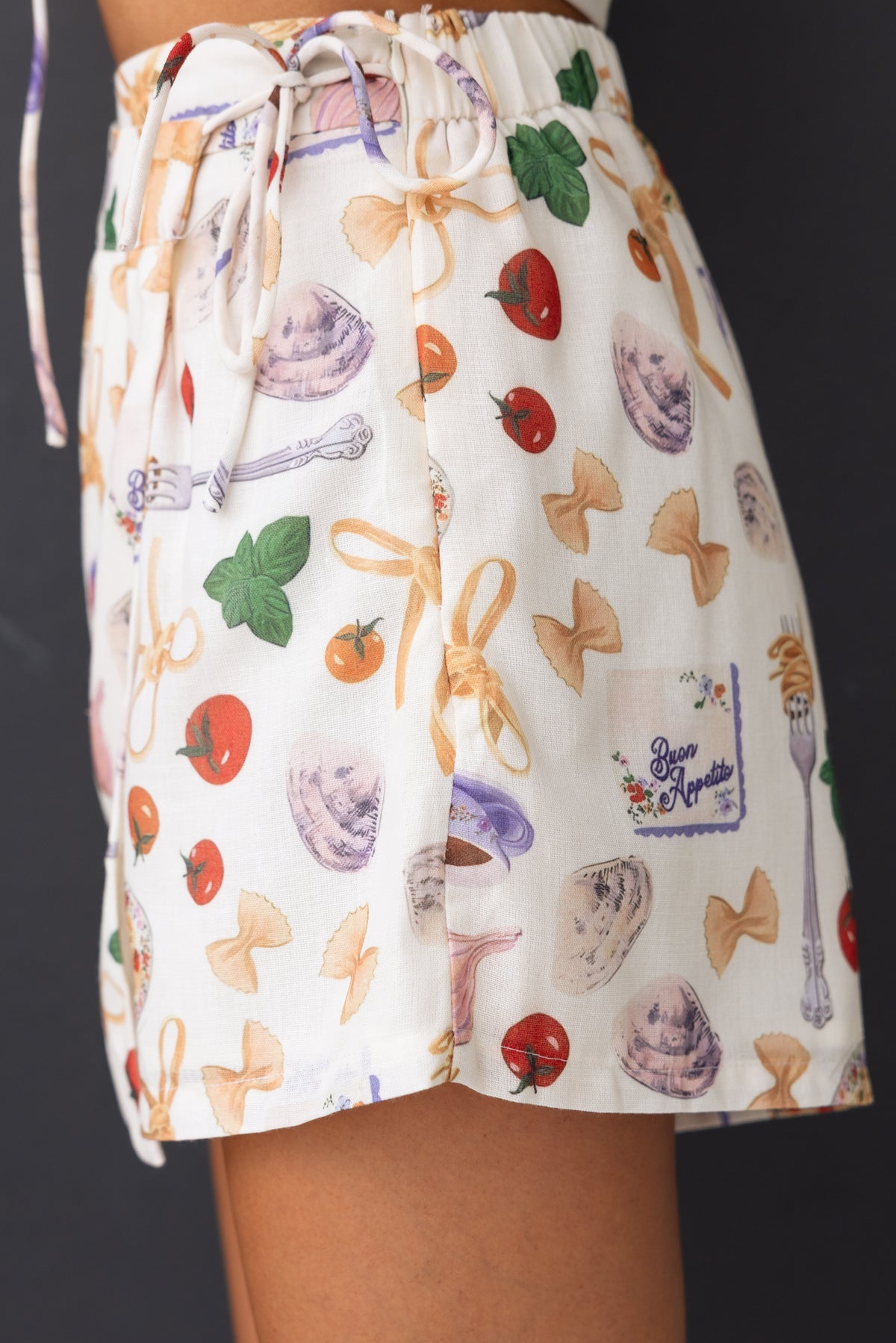 Roma Shorts features a colorful pattern with bows and food motifs, elastic waistband, perfect for casual wear.