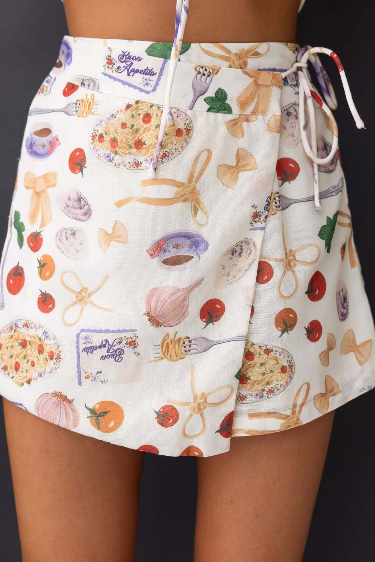 Roma Shorts featuring a fun food print skort with fabric overlay and tie, perfect for casual summer wear.