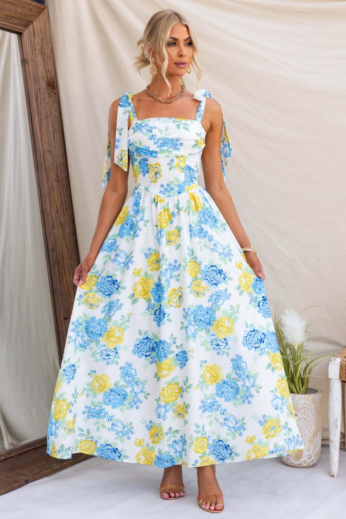 Rowena Maxi Dress featuring floral print, tie straps, and a flowy design, perfect for summer occasions.