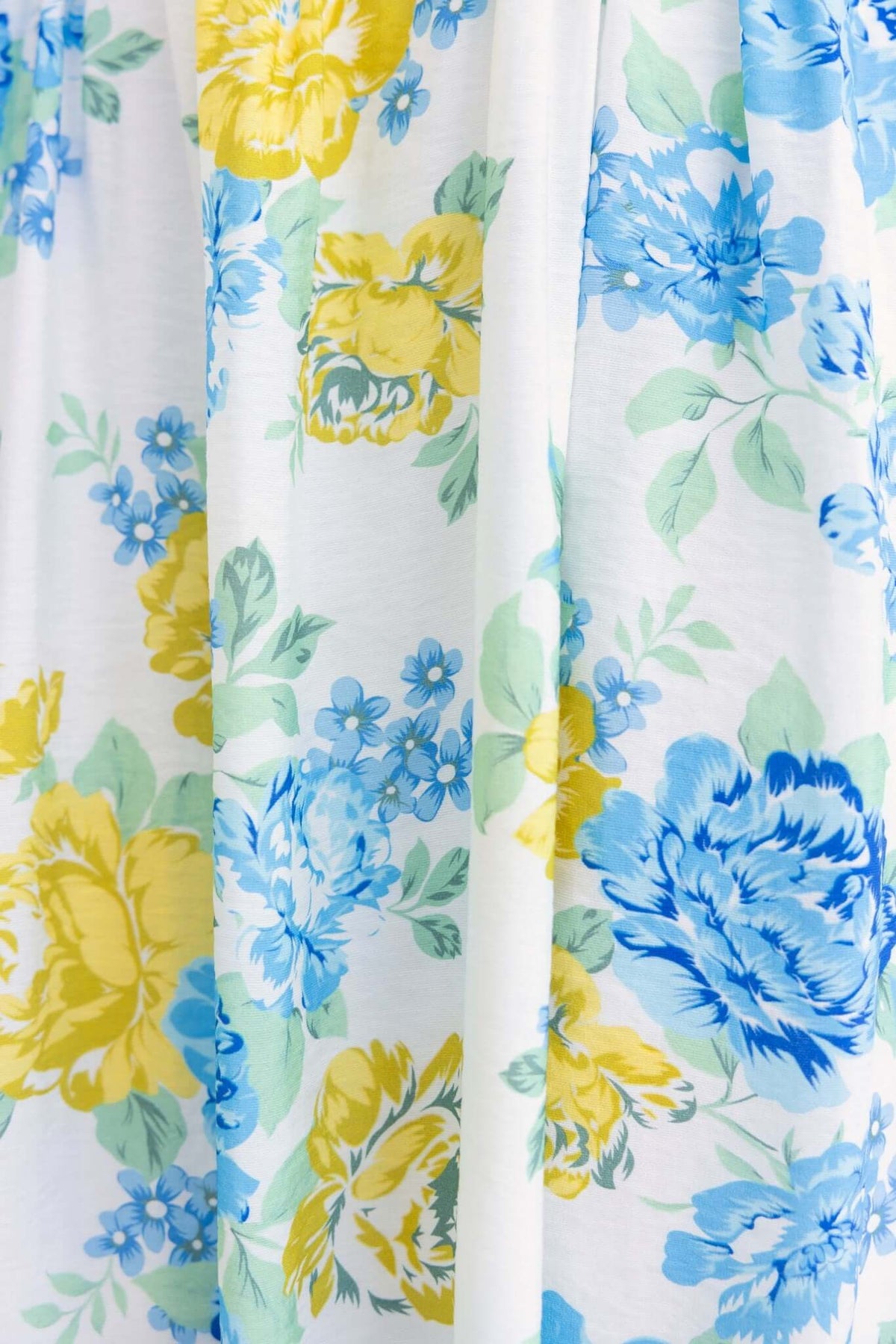 Floral print fabric featuring blue and yellow flowers perfect for Rowena Maxi Dress, showcasing vibrant summer vibes.