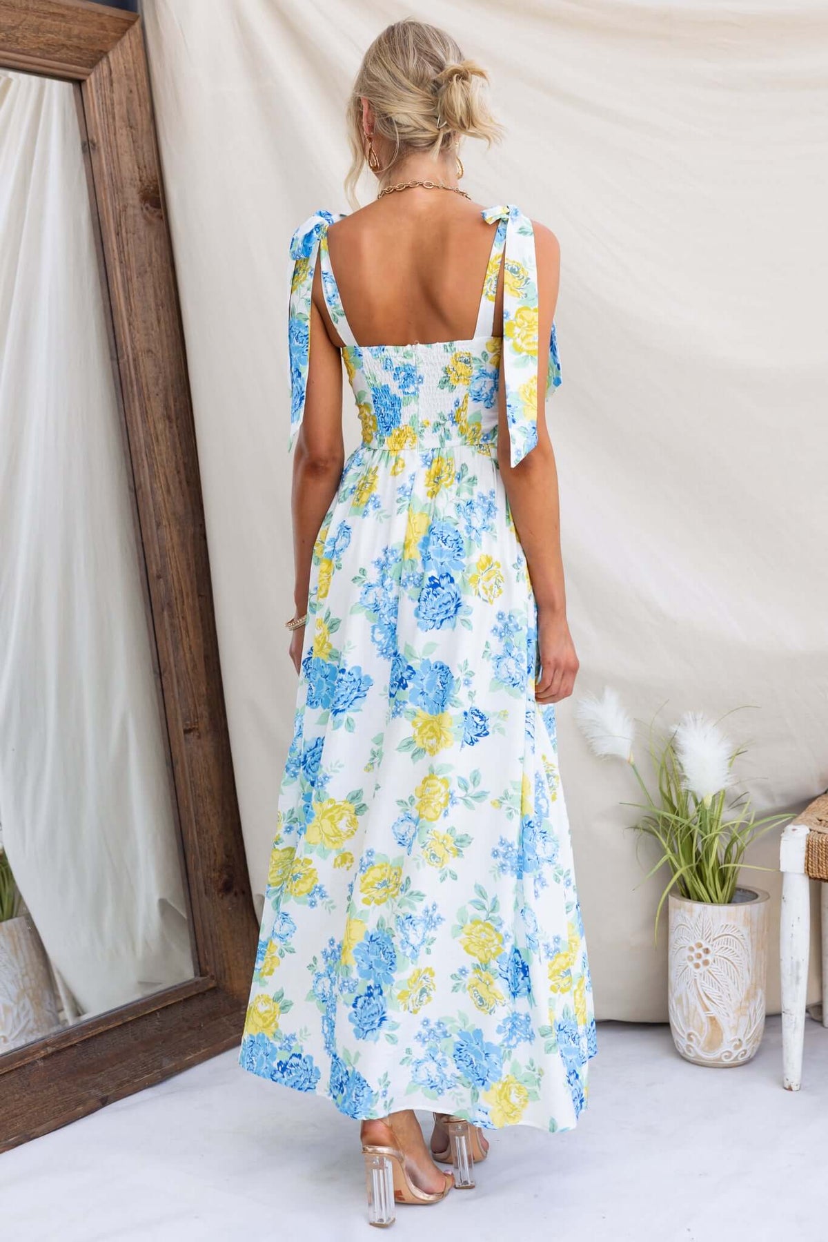 Back view of Rowena Maxi Dress with tie straps and floral print, perfect for summer outings.
