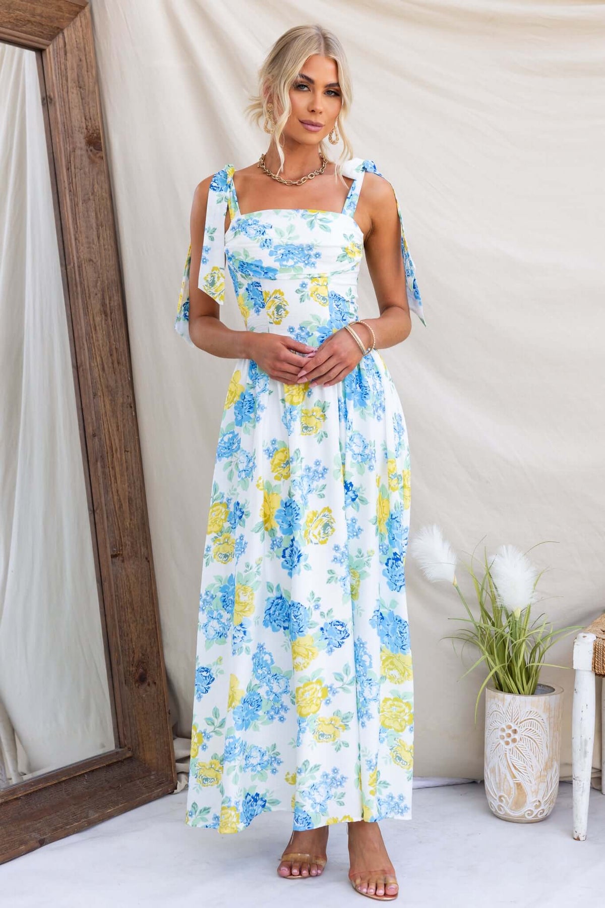 Rowena Maxi Dress featuring a floral design, tie straps, and a flowing silhouette, perfect for summer occasions.