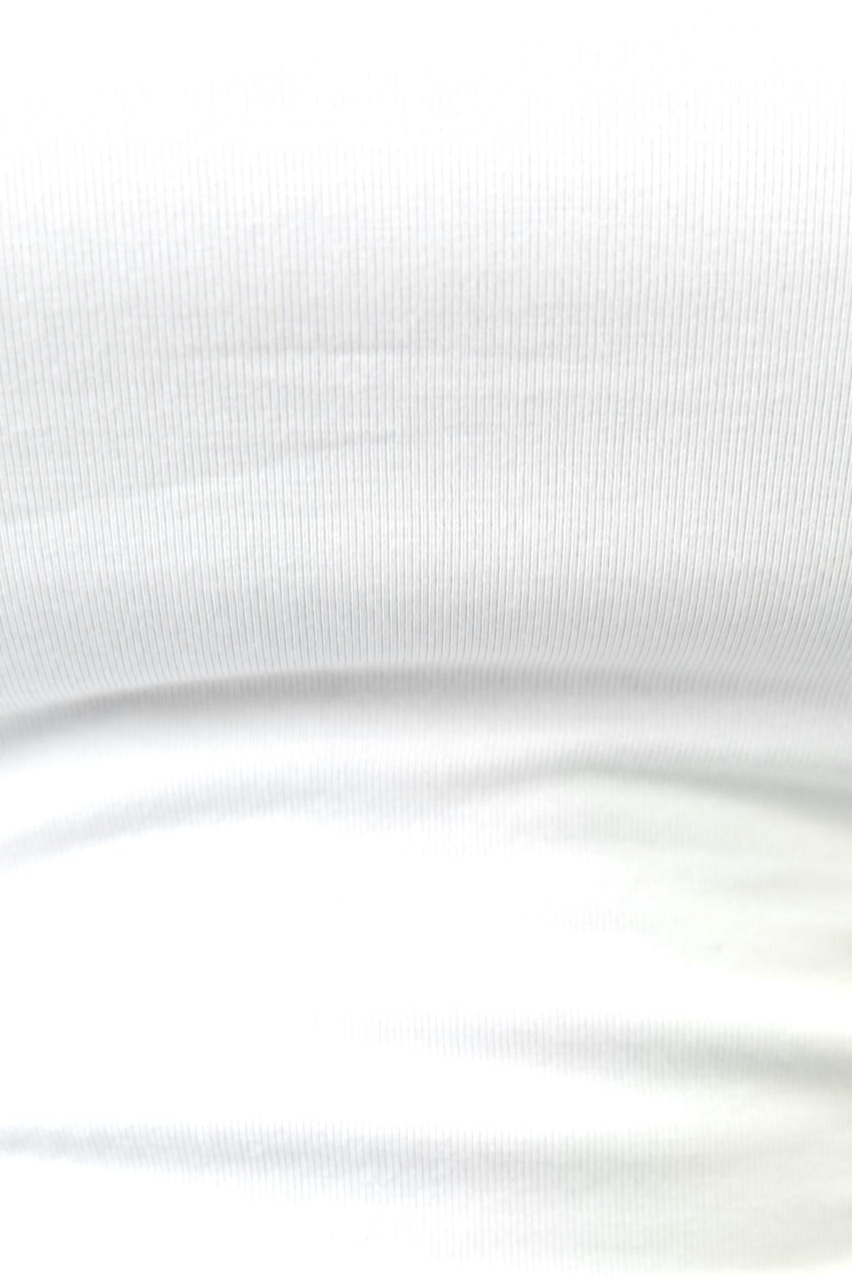 Close-up of a white Rumba Top, featuring a high neckline and stretchy ribbed fabric.