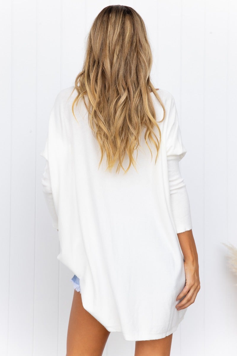 Rear view of a woman in a cozy oversized white Bonnie Knit top with full length sleeves, showcasing the relaxed fit.