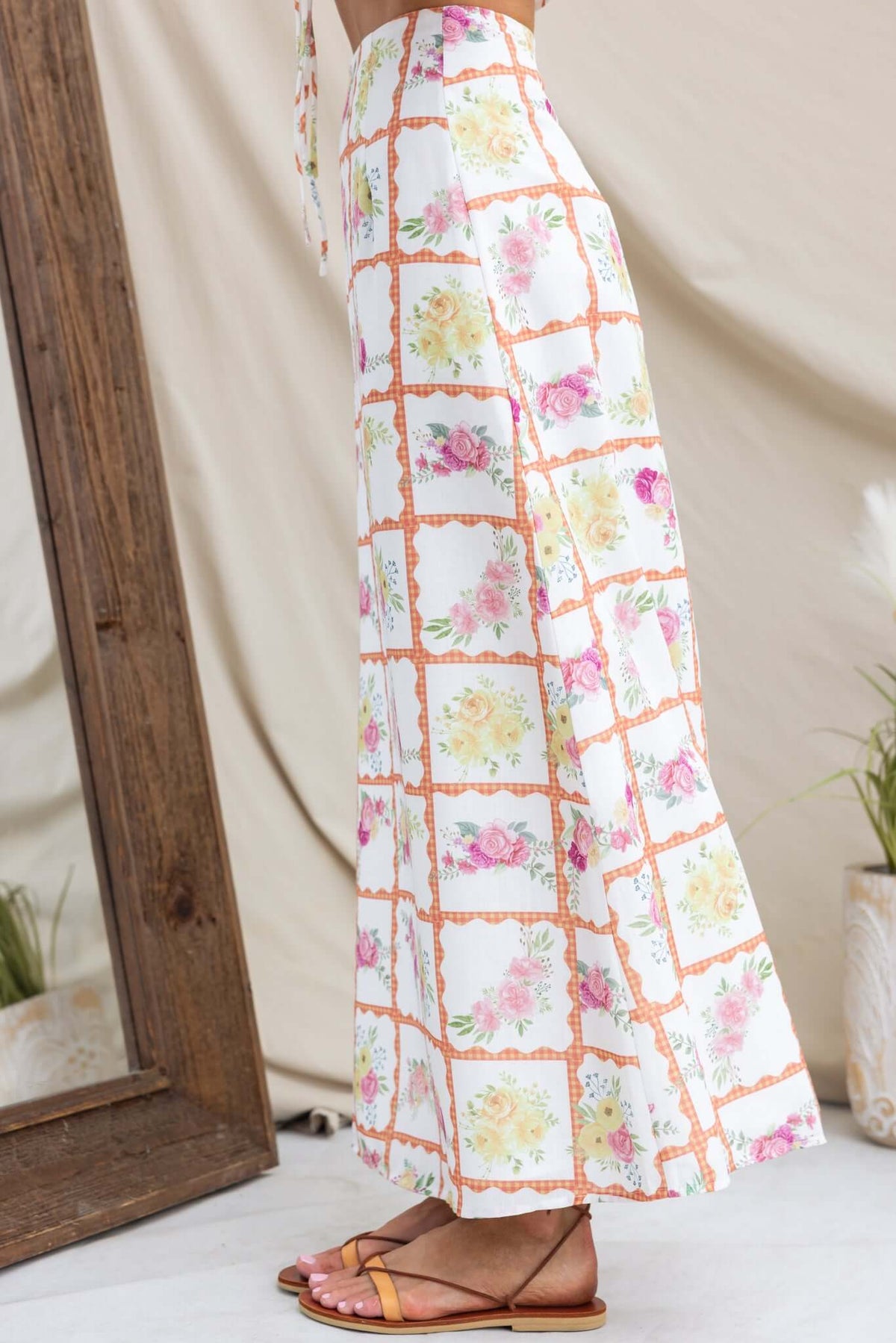 Shawnee Maxi Skirt featuring a floral print, mid-high waist, and linen texture, styled with sandals.