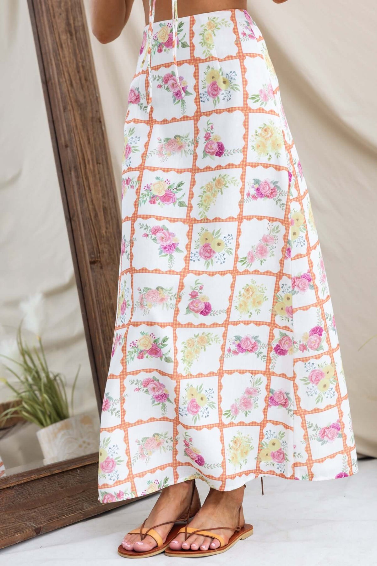 Shawnee maxi skirt featuring floral pattern, mid-high waist, linen look, and lined design, paired with minimalist sandals.