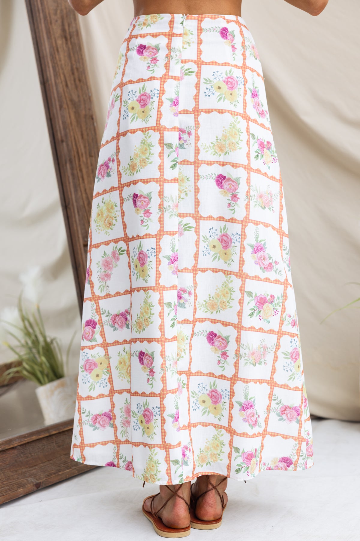 Back view of Shawnee Maxi Skirt with floral print, mid-high waist, and lined linen look design.