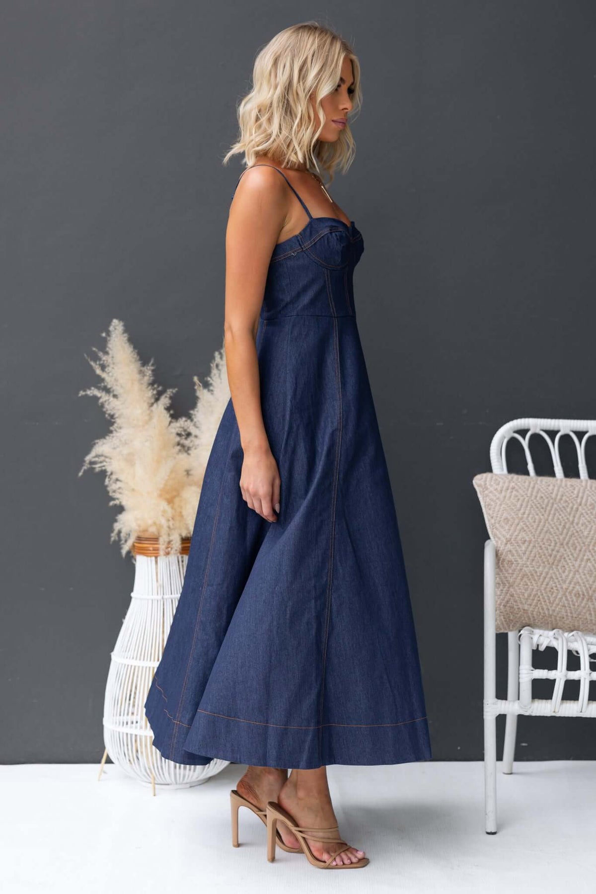 Stylish Sylvi denim midi dress with adjustable straps and boning, perfect for chic summer outings.