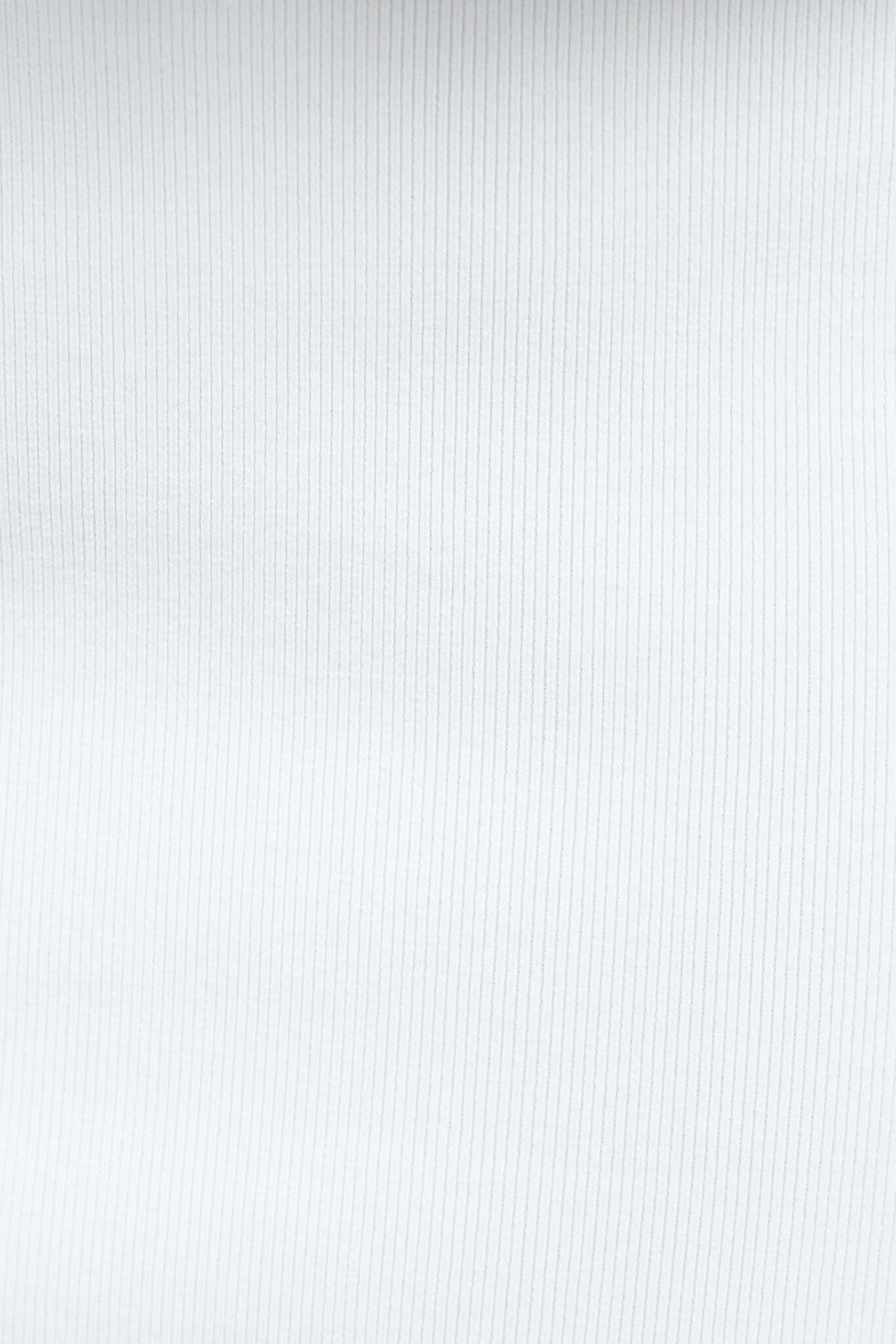 Close-up of the soft, stretchy knit material of the Tammie Midi Skirt, featuring a fine ribbed texture in white.
