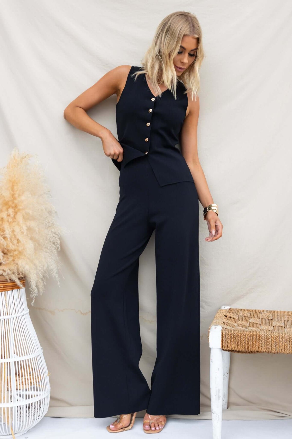 Tammie Pants featuring mid-high waist, elastic waistband, and stretchy knit material, worn in a stylish outfit.