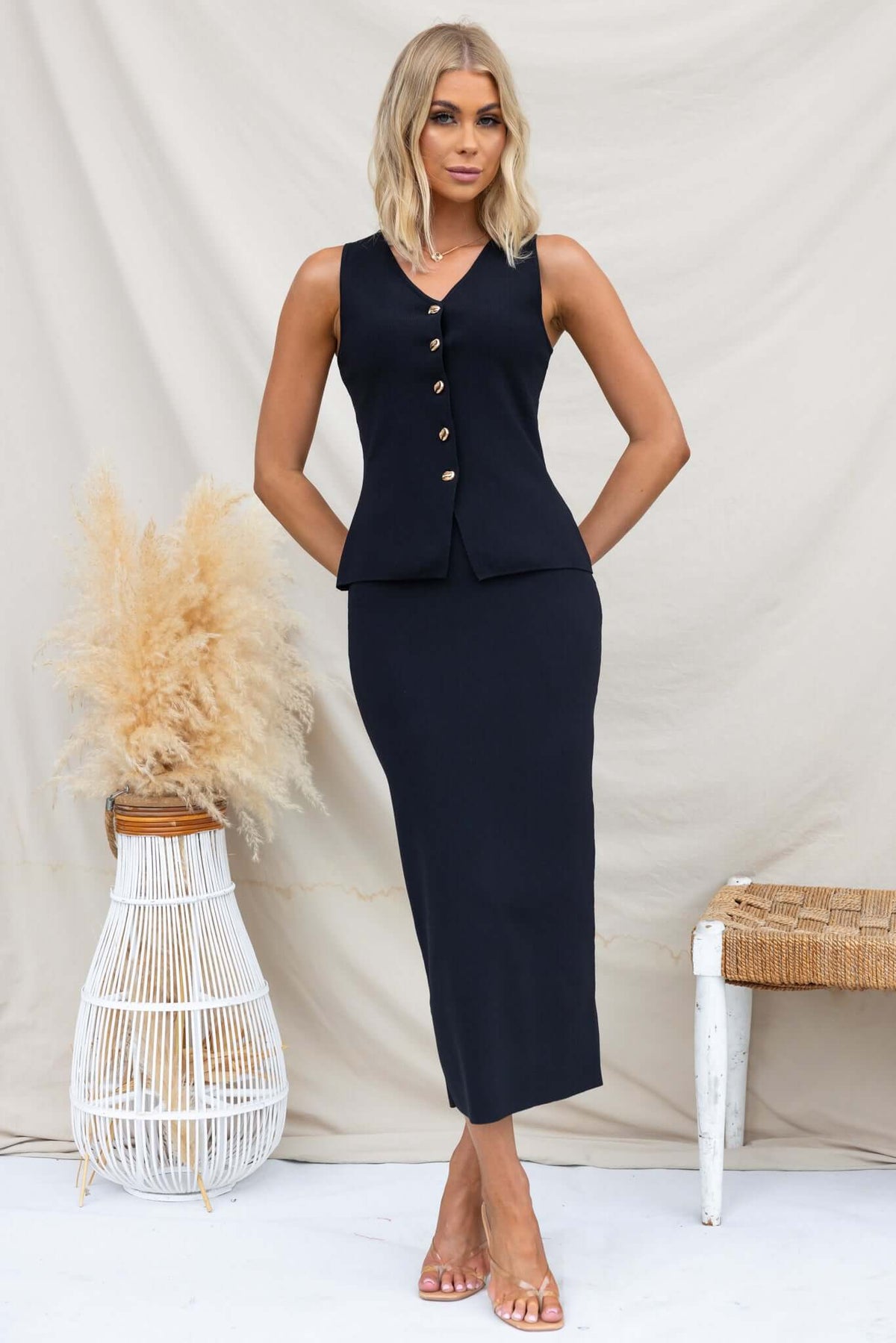 Stylish Tammie Top in black with button-up front, perfect for a chic outfit, featuring a fitted design and stretchy knit fabric.