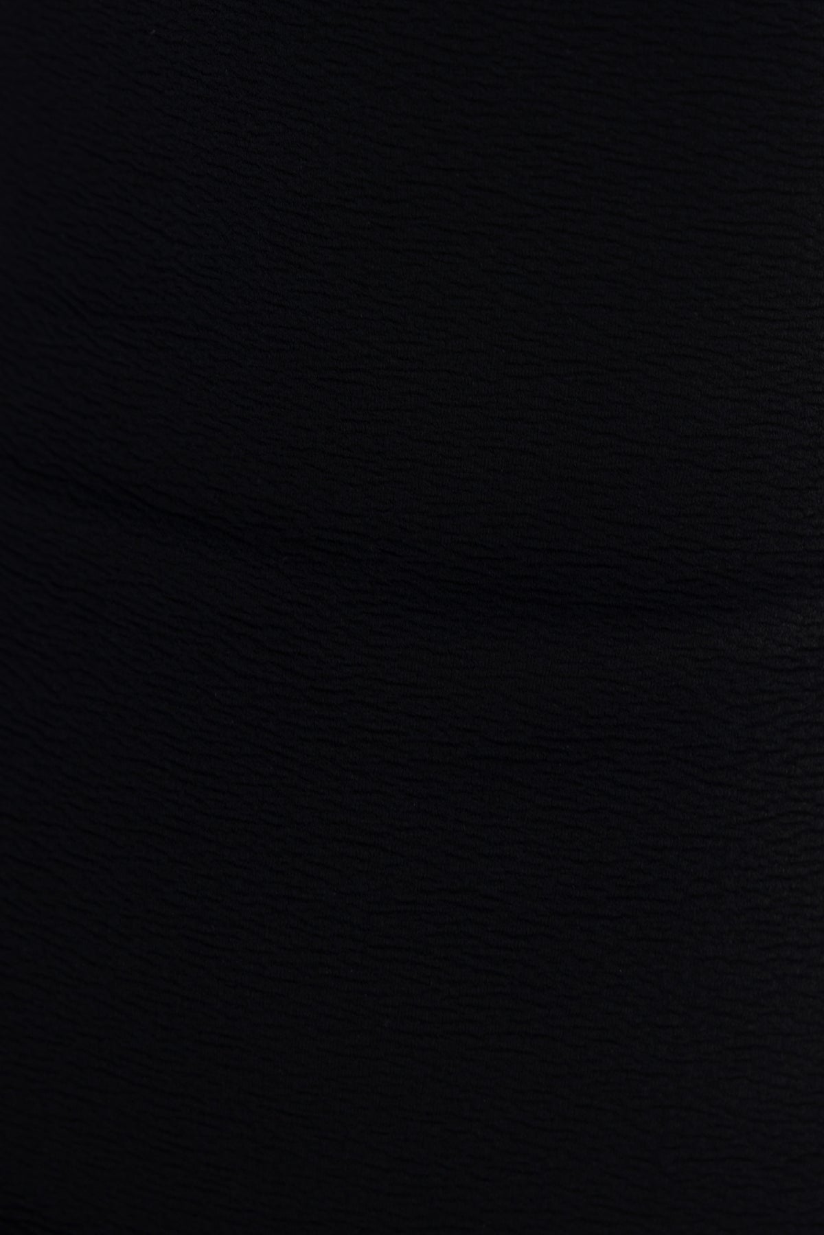 Close-up of textured black fabric showcasing the material of the Tavisha Maxi Dress with stretch for comfort.