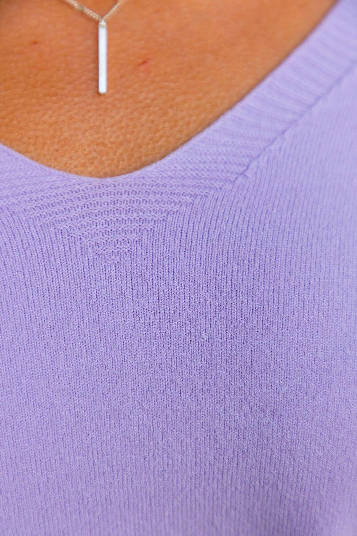 Close-up of the lightweight knit Tayla Top featuring a V-neckline in soft purple.