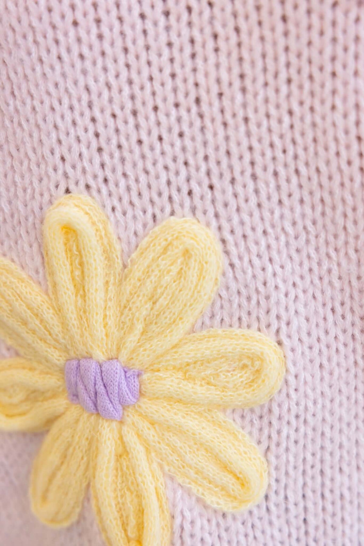 Close-up of pink knit jumper featuring a yellow embroidered flower detail for the Thought Of You Jumper.