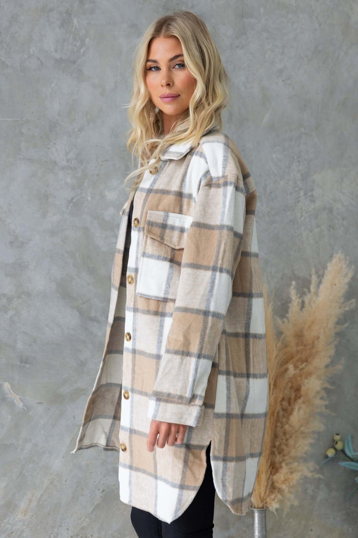 Model wearing the Torres Shacket, a button-up plaid shirt jacket with a relaxed fit and two bust pockets.