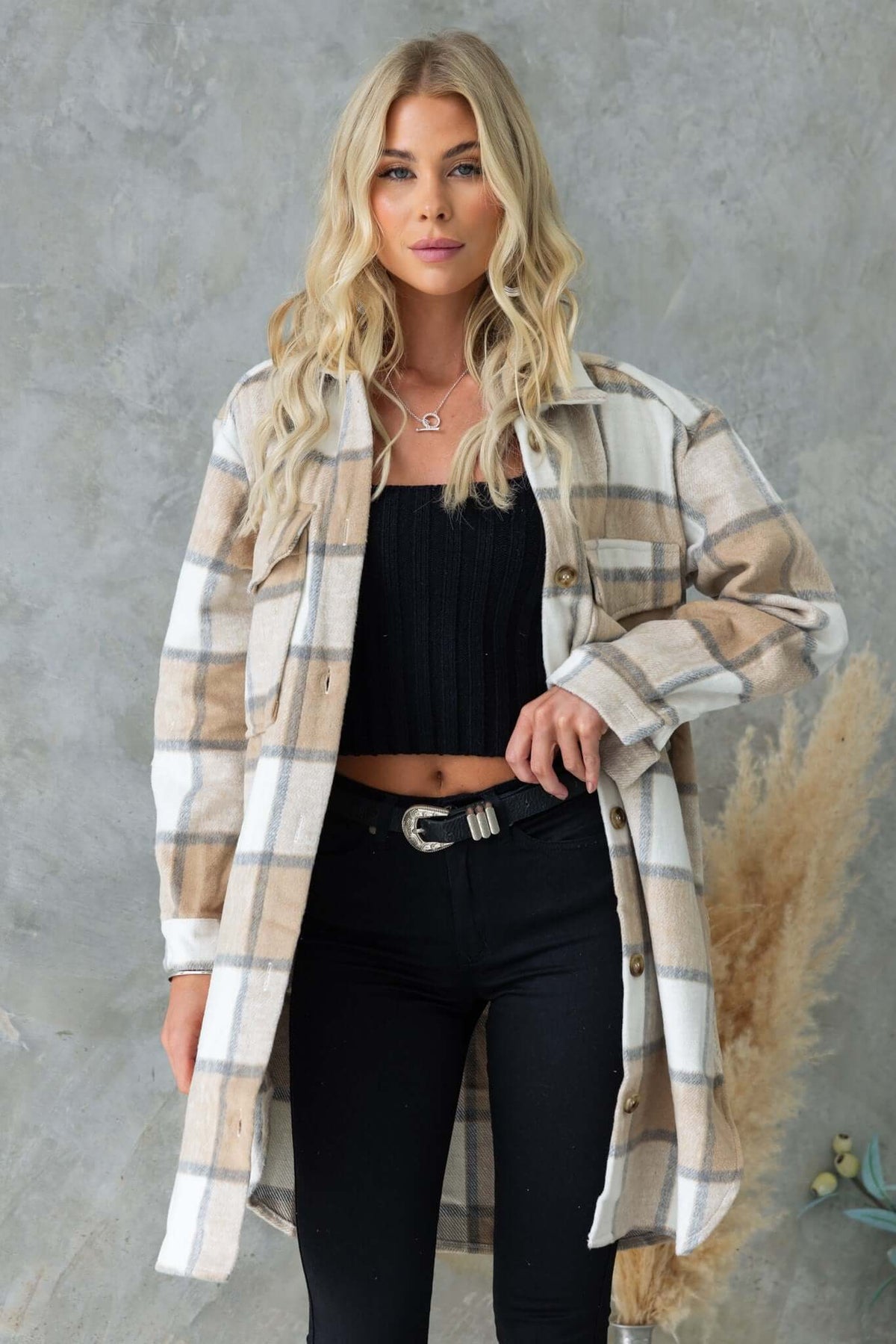 Model showcasing a stylish Torres Shacket with a collar, button-up front, and pockets, paired with black jeans.