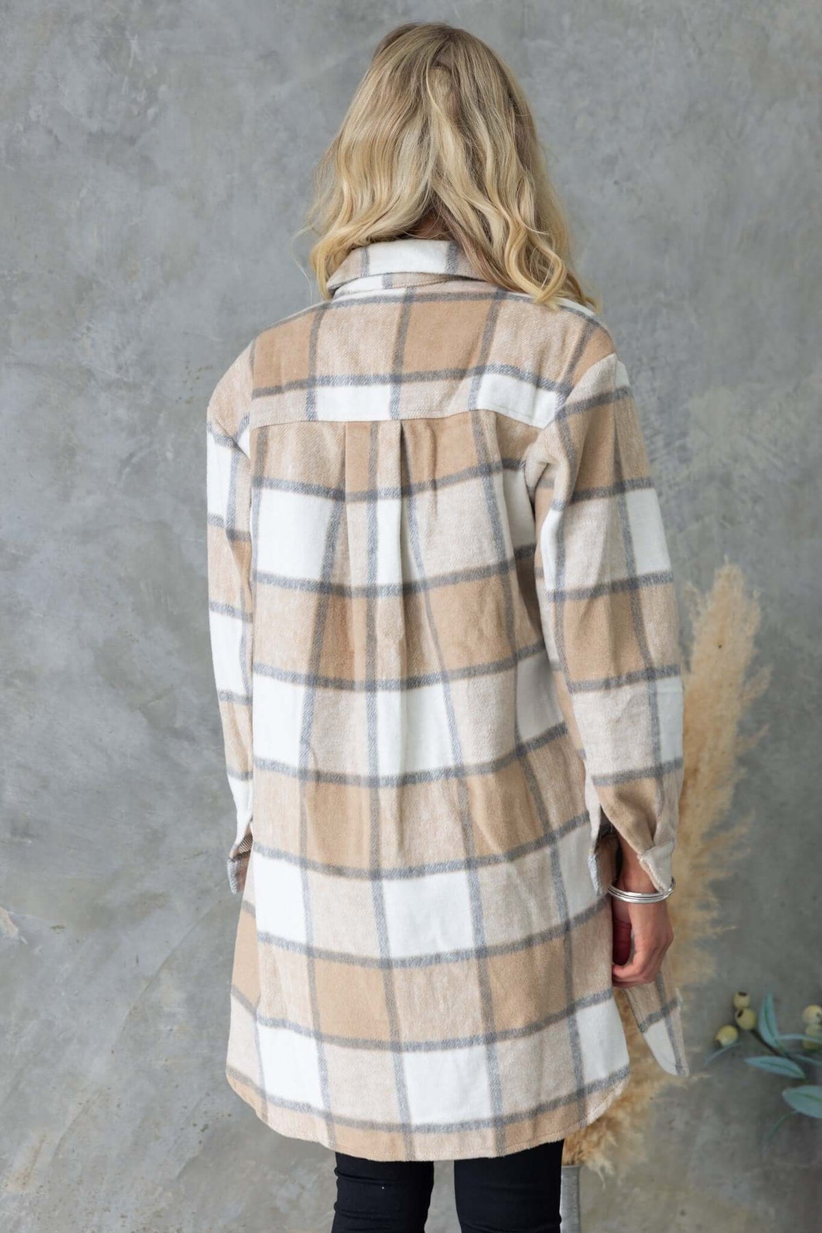 Back view of Torres Shacket in plaid design, featuring a collar and button-up front, styled for a relaxed fit.