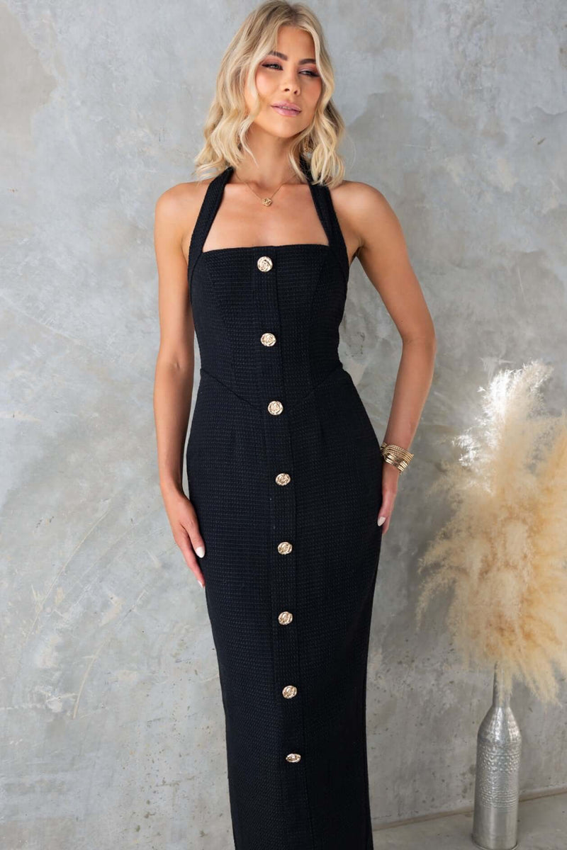 Tortona Maxi Dress featuring a halter neckline, faux buttons, and a stylish split at the back, perfect for any occasion.