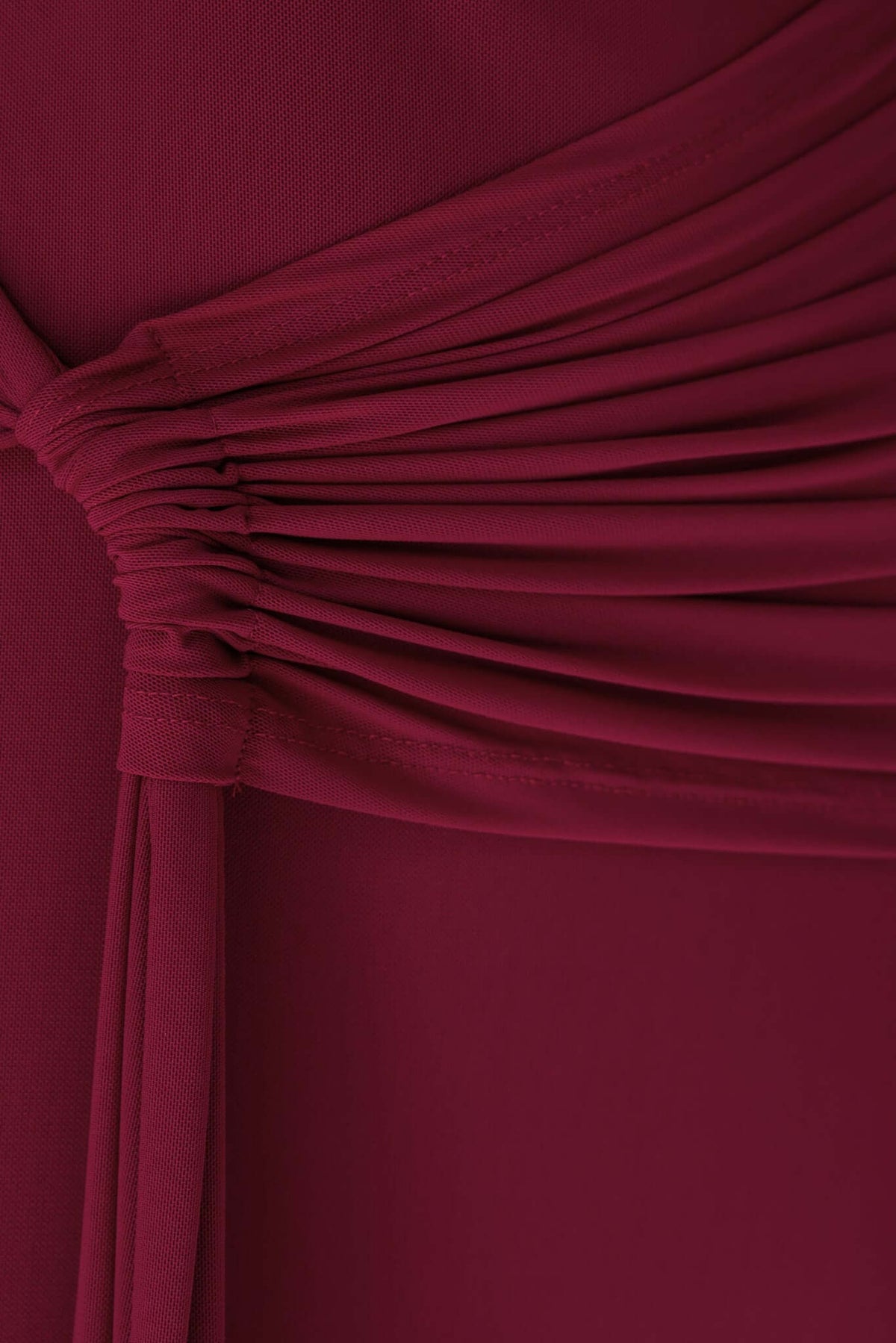 Close-up of the layered mesh detail on a burgundy ultra maxi dress, showcasing its elegant design and texture.