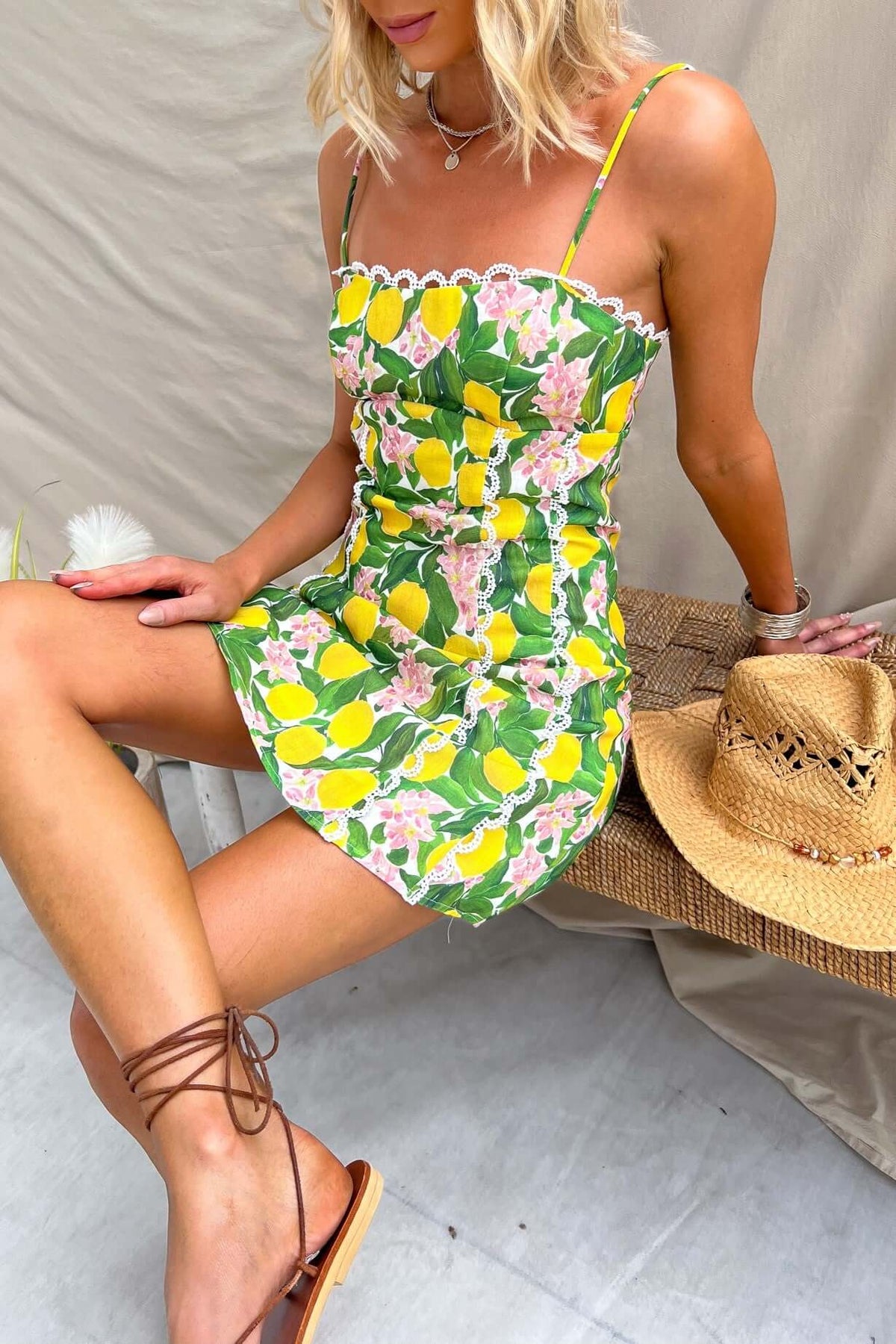 Umeeka Dress featuring adjustable straps, lemon floral design, and a casual summer look, styled with a straw hat.