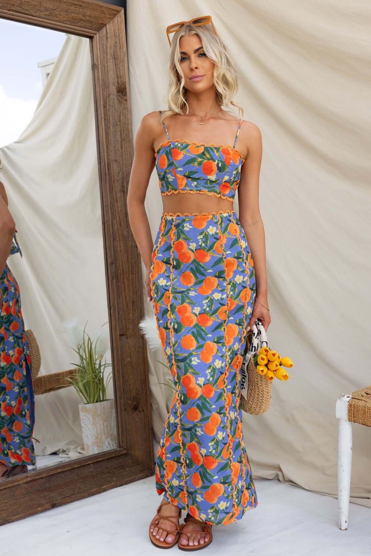 Model in Umeeka Maxi Skirt featuring floral print, mid-high waist, and back split, styled with matching top.