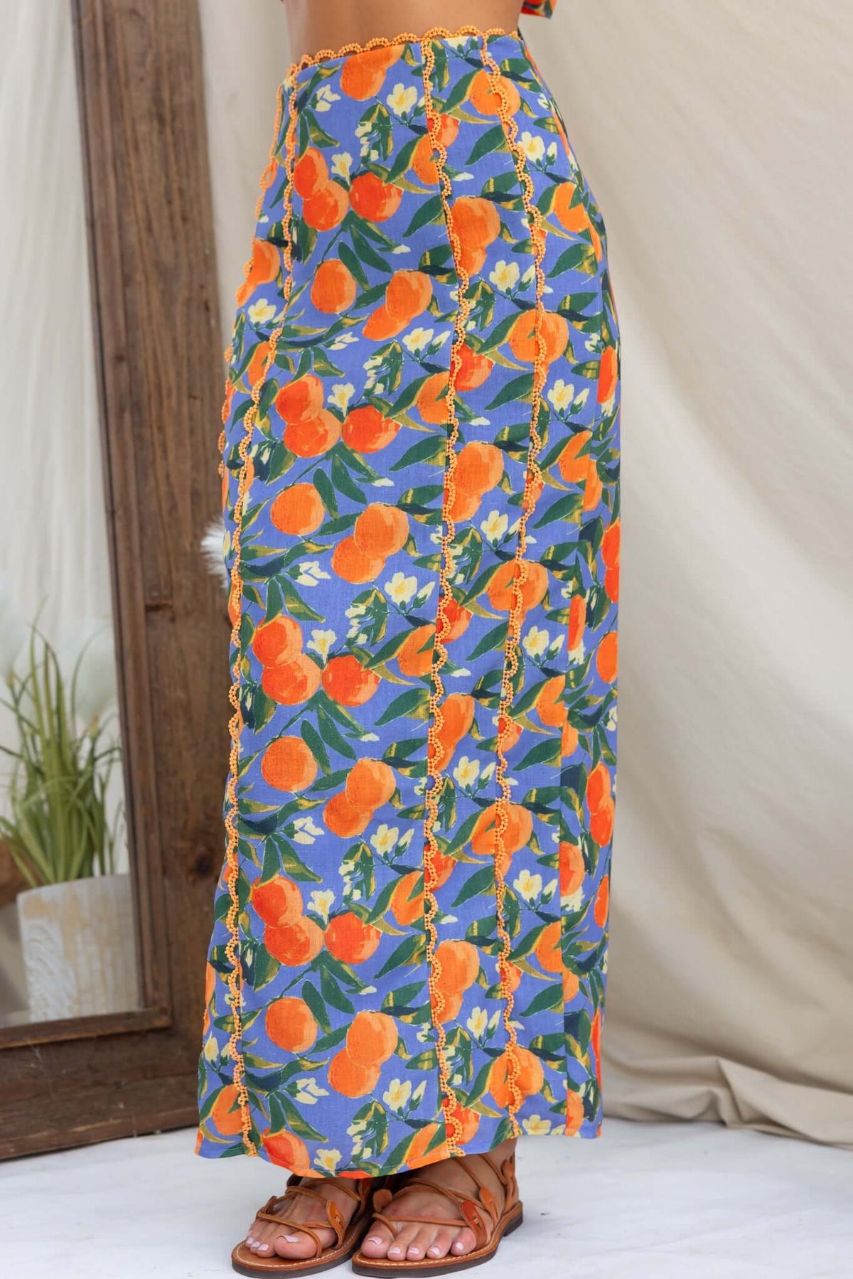Umeeka Maxi Skirt featuring vibrant floral print with mid-high waist fit and back split detail.