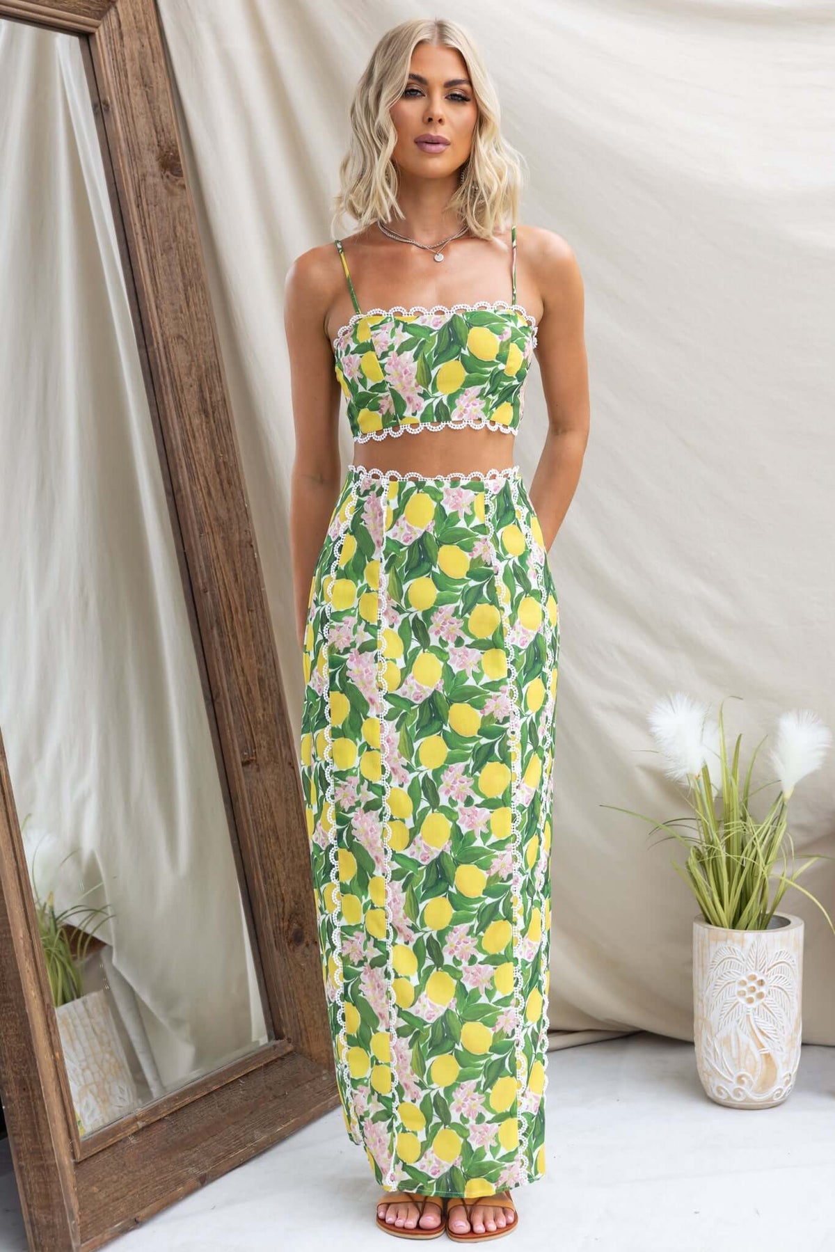 Model wearing Umeeka Maxi Skirt with lemon print, mid-high waist fit and back split, styled with matching crop top.