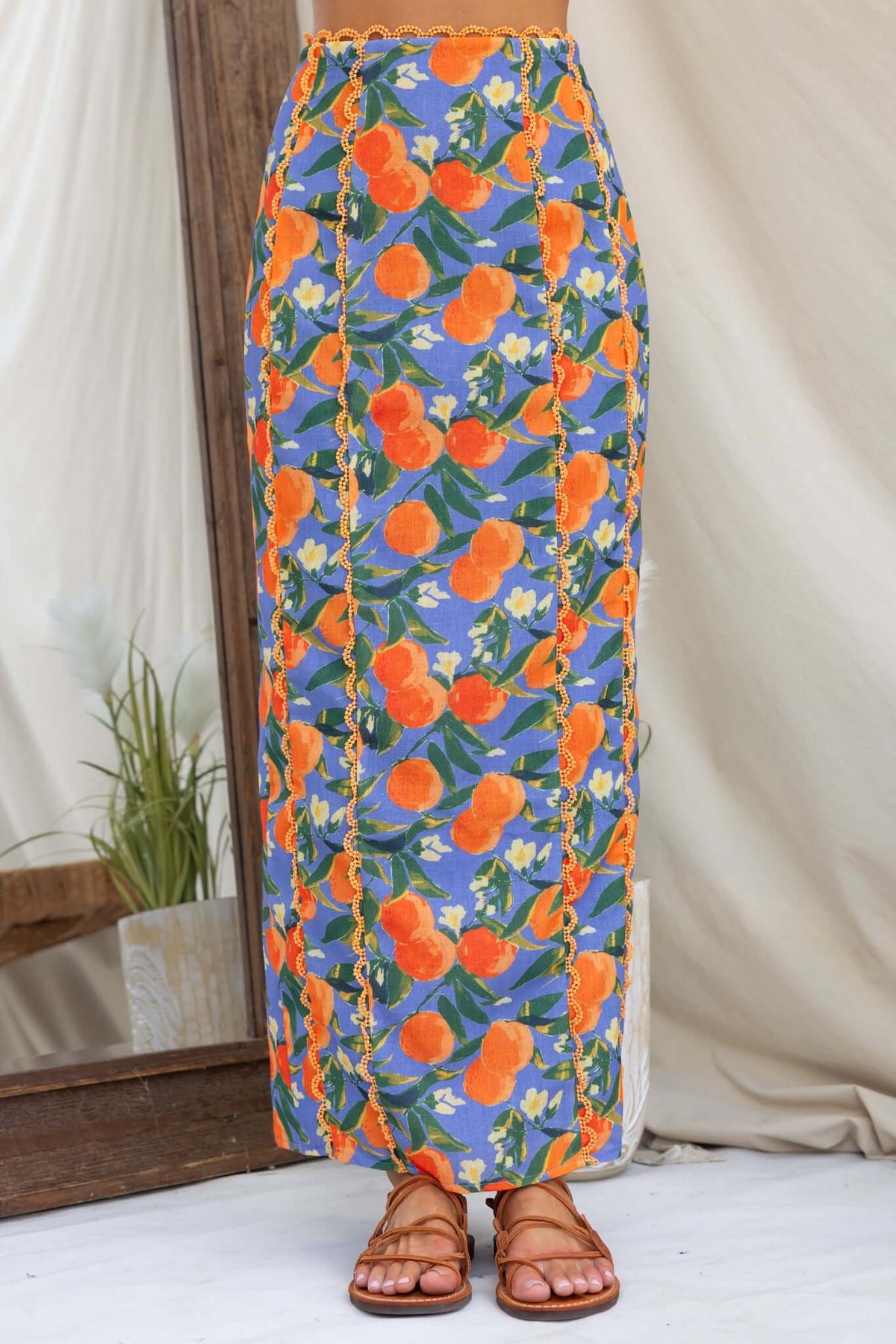 Umeeka Maxi Skirt in floral print with orange and blue, featuring a mid-high waist and back split.