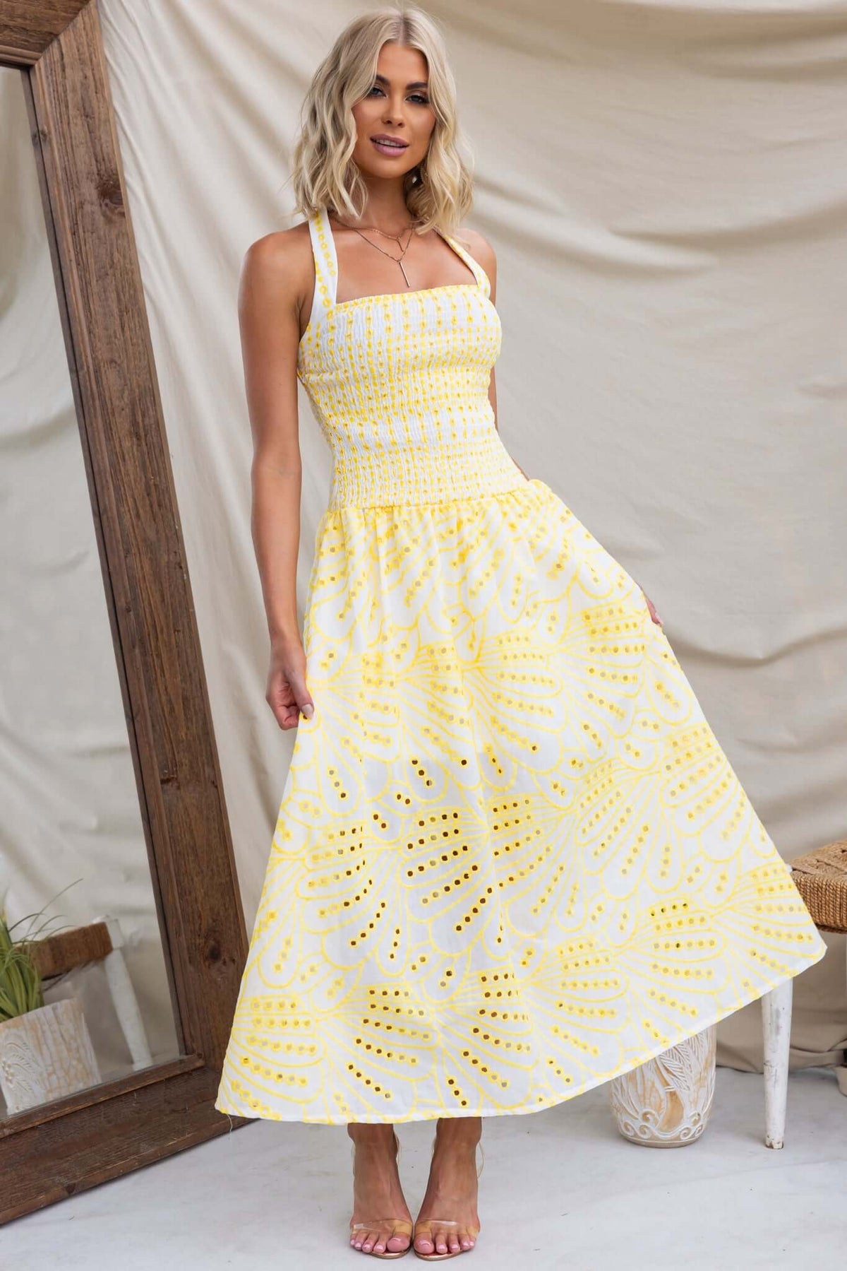 Urena Midi Dress featuring a halter neckline and elastic bodice in Anglaise material, styled with a yellow design.