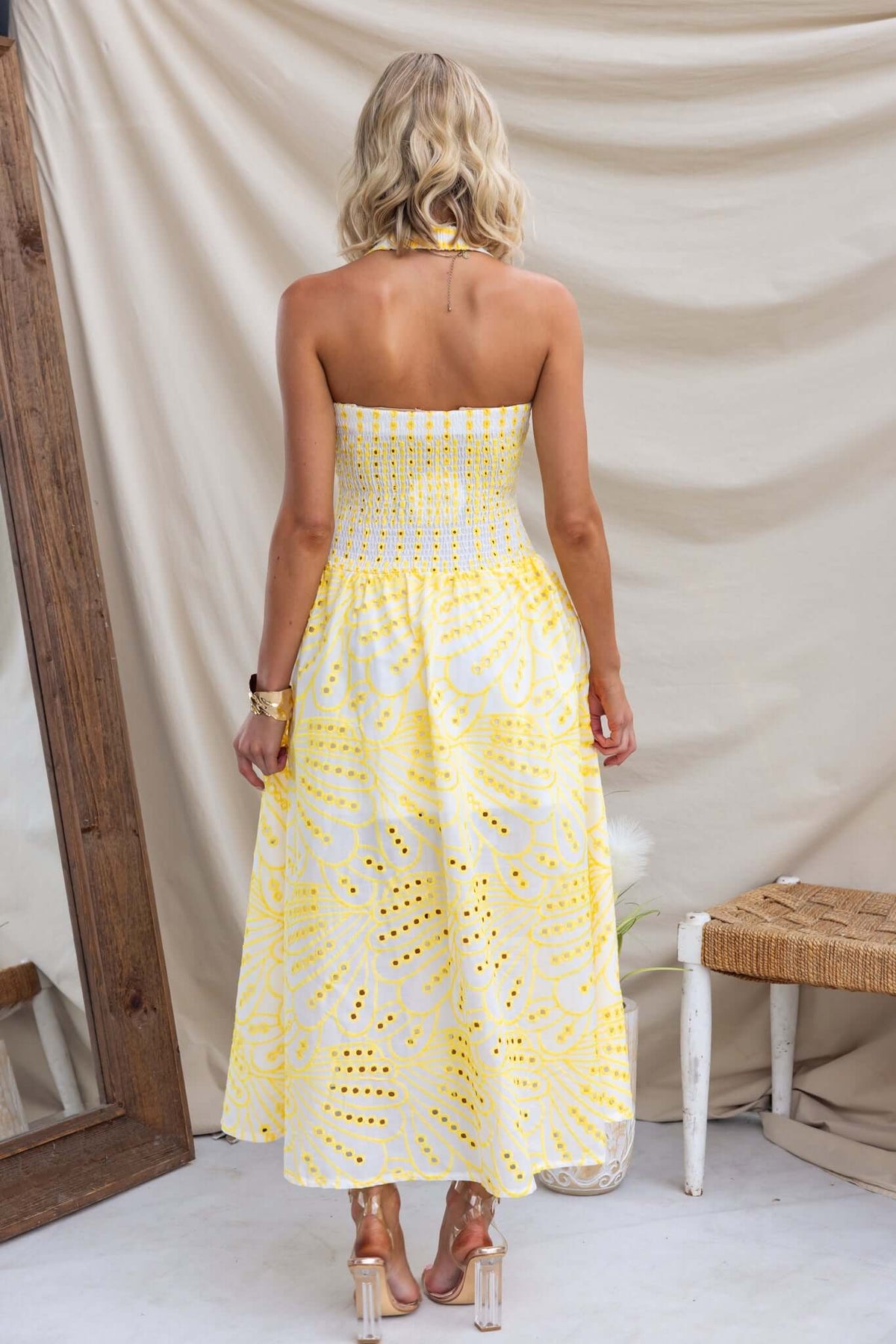 Back view of Urena Midi Dress in yellow Anglaise fabric, featuring halter neckline and elastic bodice.